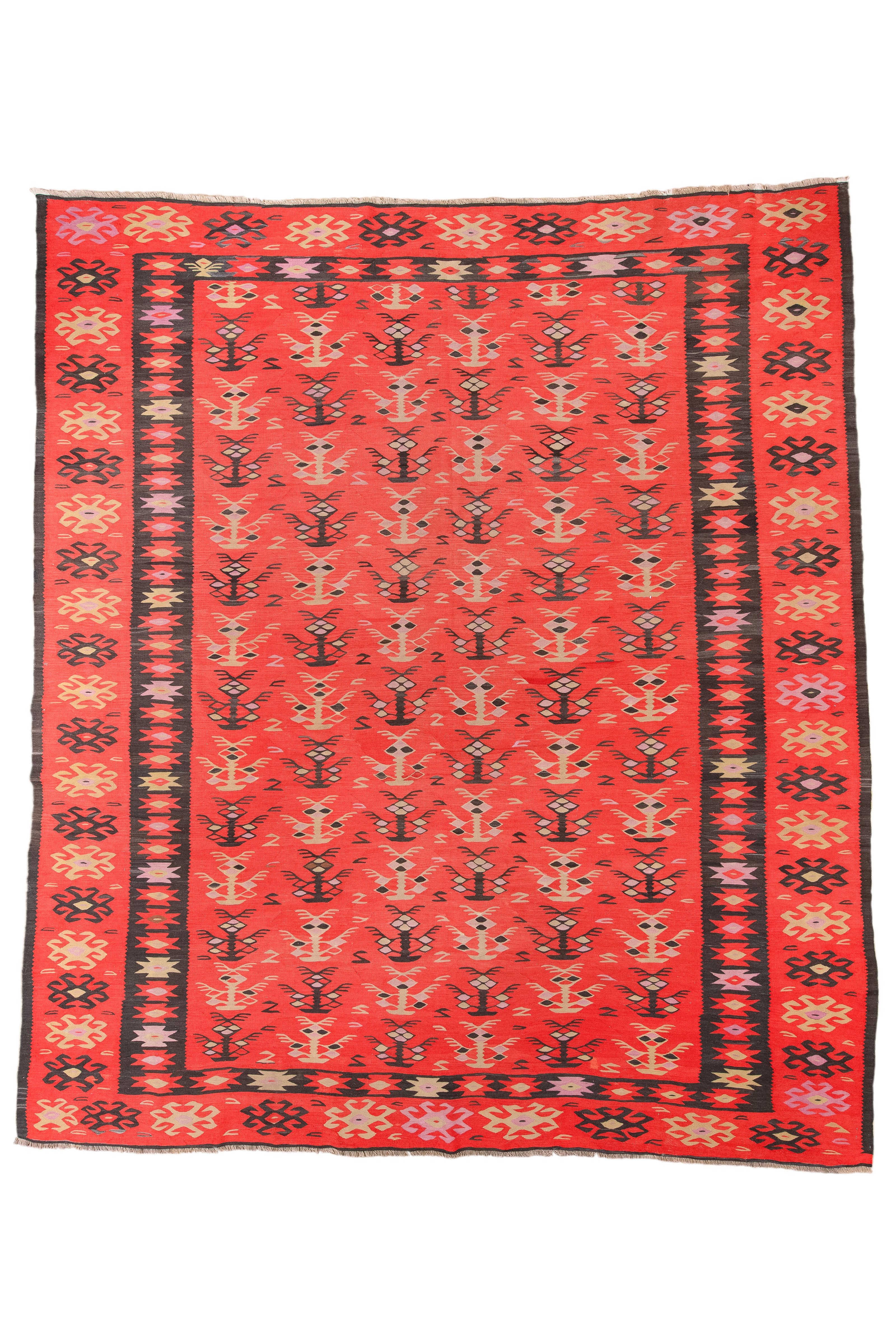 This Bessarabian flat weave rug, crafted in 1910, exudes elegance with its Sangria and Deep Charcoal tones. Measuring 10X12, it features the distinctive Sarkoy Design known for its tight, fine weave and regional aesthetic. Sarkoy rugs are celebrated