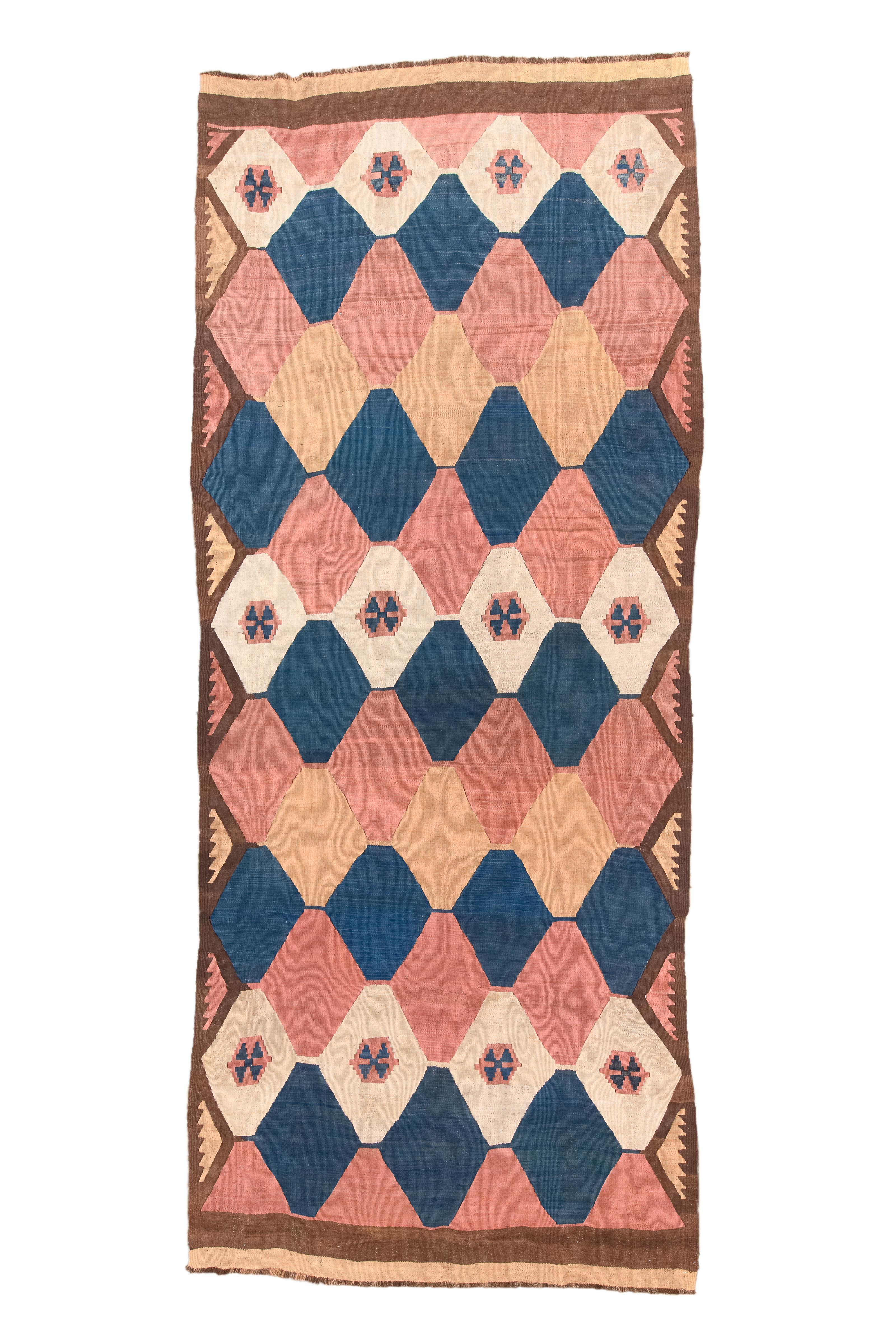 Introducing a 1920 Tazik Kilim Runner Rug, measuring 6x14'6 feet, embellished with the delicate hues of Rose Petals and Medieval Blue. This Runner Rug seamlessly blends the softness of Rose Petal with the depth of Medieval Blue, capturing the