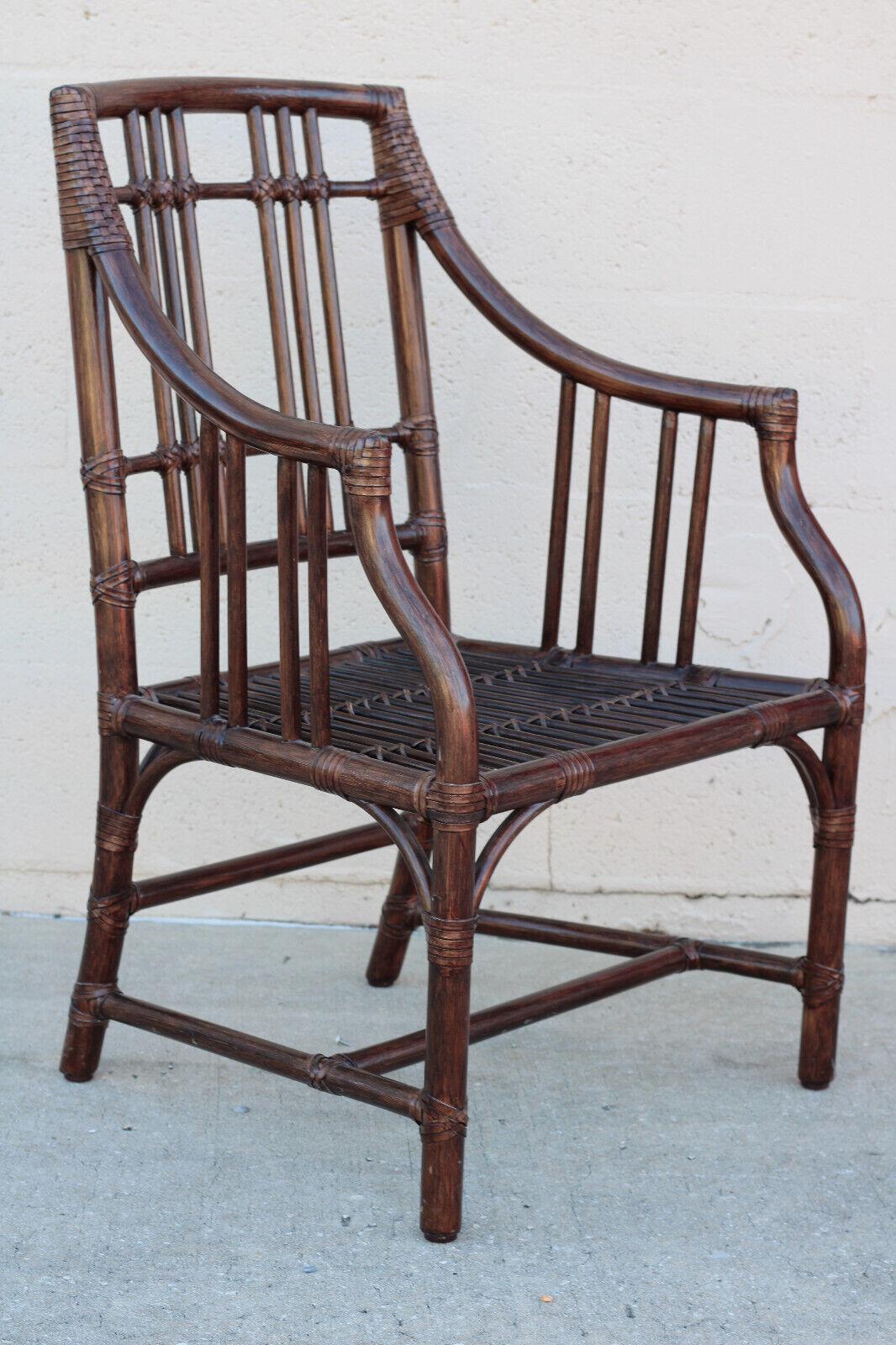 A set of Four McGuire Balboa Rattan Arm Chairs or Dining Chairs. Featuring Craftsman details, the Balboa Arm Chair, designed by Elinor McGuire, is a classic form that could fit many different spaces. This set of chairs has a rich dark tobacco
