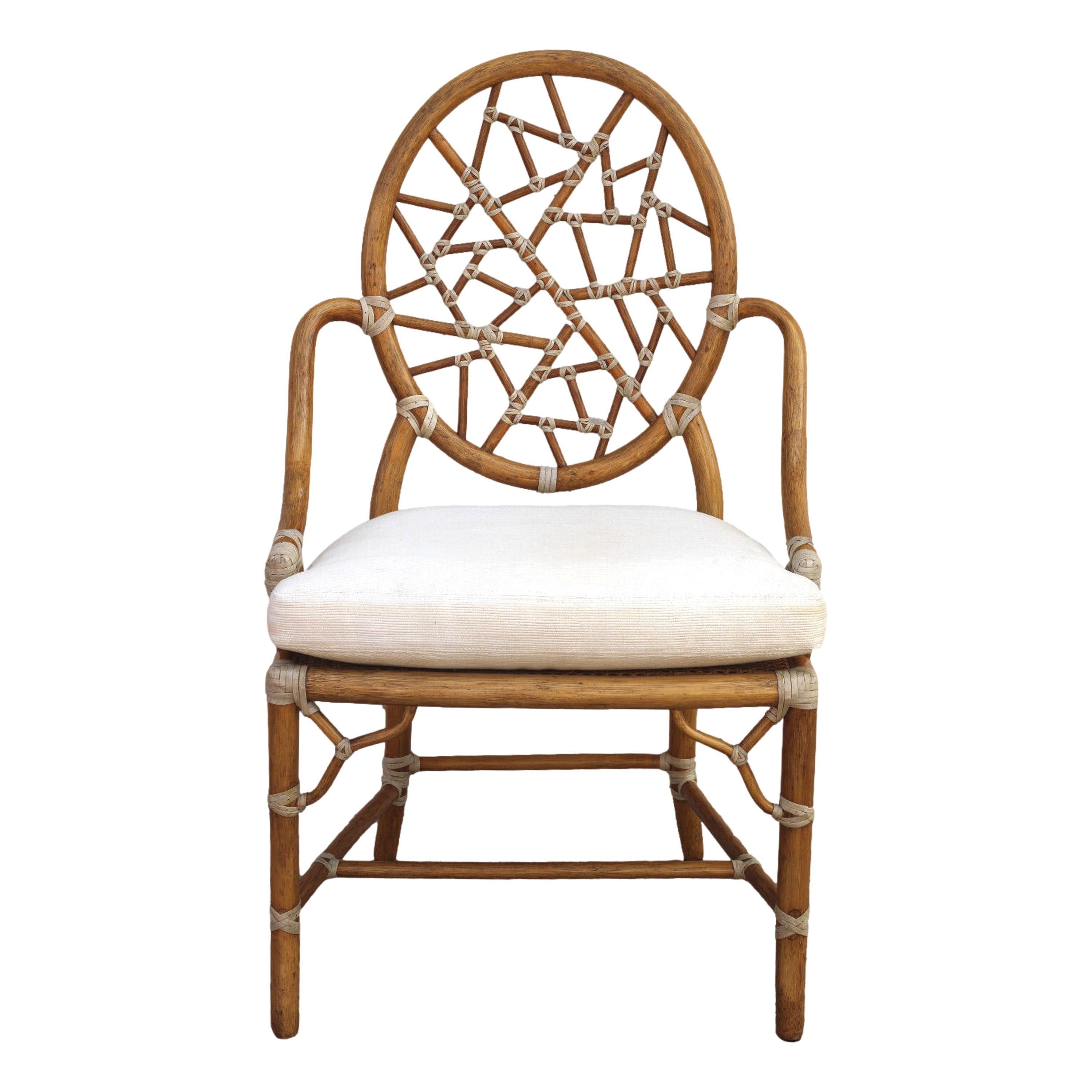 A set of six iconic cracked ice chairs designed by breakthrough innovator Elinor McGuire in 1968. The design is famous for its rattan oval back that frames smaller rattan pieces bound by rawhide, creating the impression of cracked ice or shattered