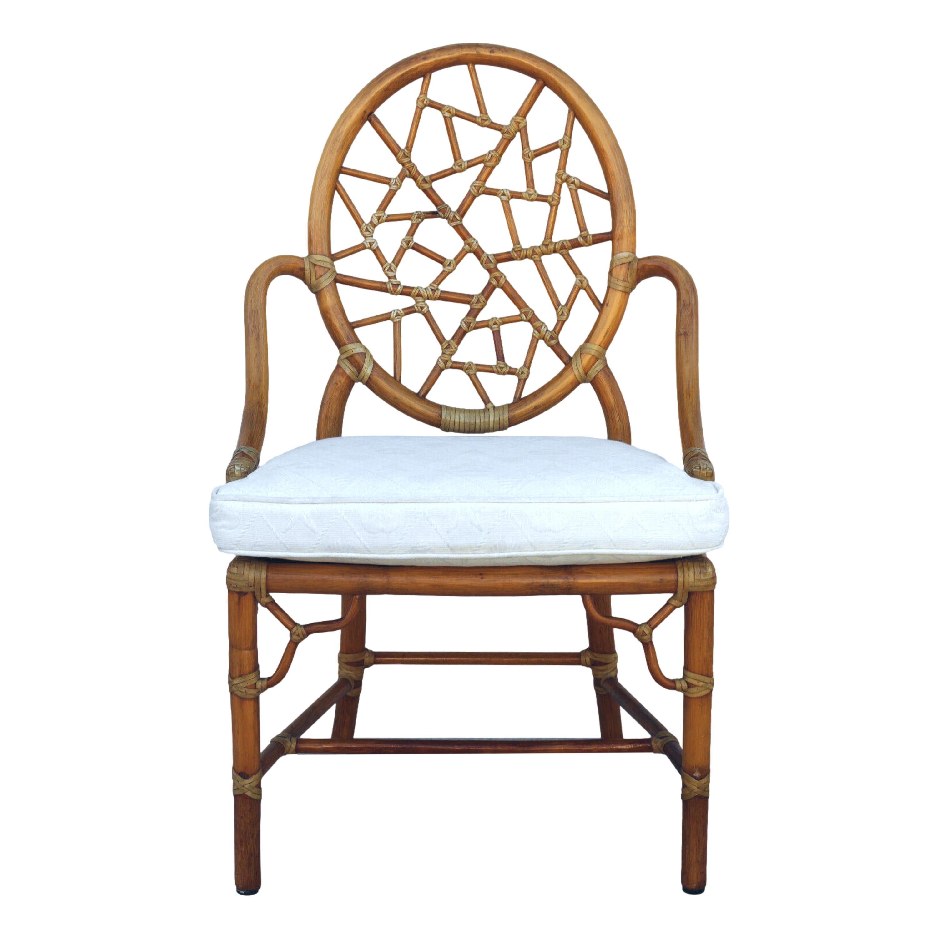 Set of eight iconic cracked ice chairs designed by breakthrough innovator Elinor McGuire in 1968. The design is famous for its rattan oval back that frames smaller rattan pieces bound by rawhide, creating the impression of cracked ice or shattered