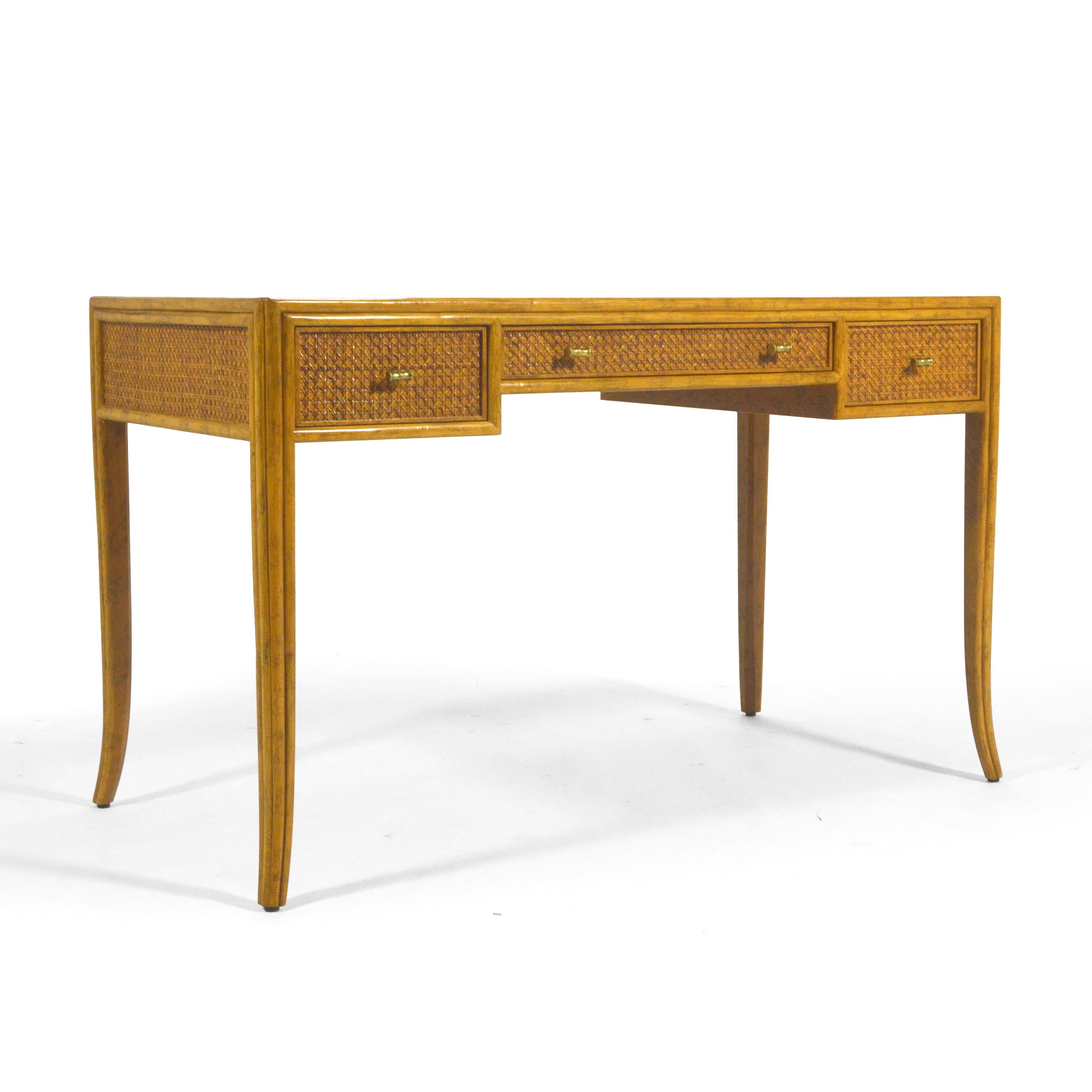 This exquisite design by Elinor McGuire for McGuire of San Fransisco is an exercise in subtle beauty and refined detailing. With a body covered in cane, an oak top, slightly splayed legs, and solid brass bamboo-form pulls, the desk is expertly