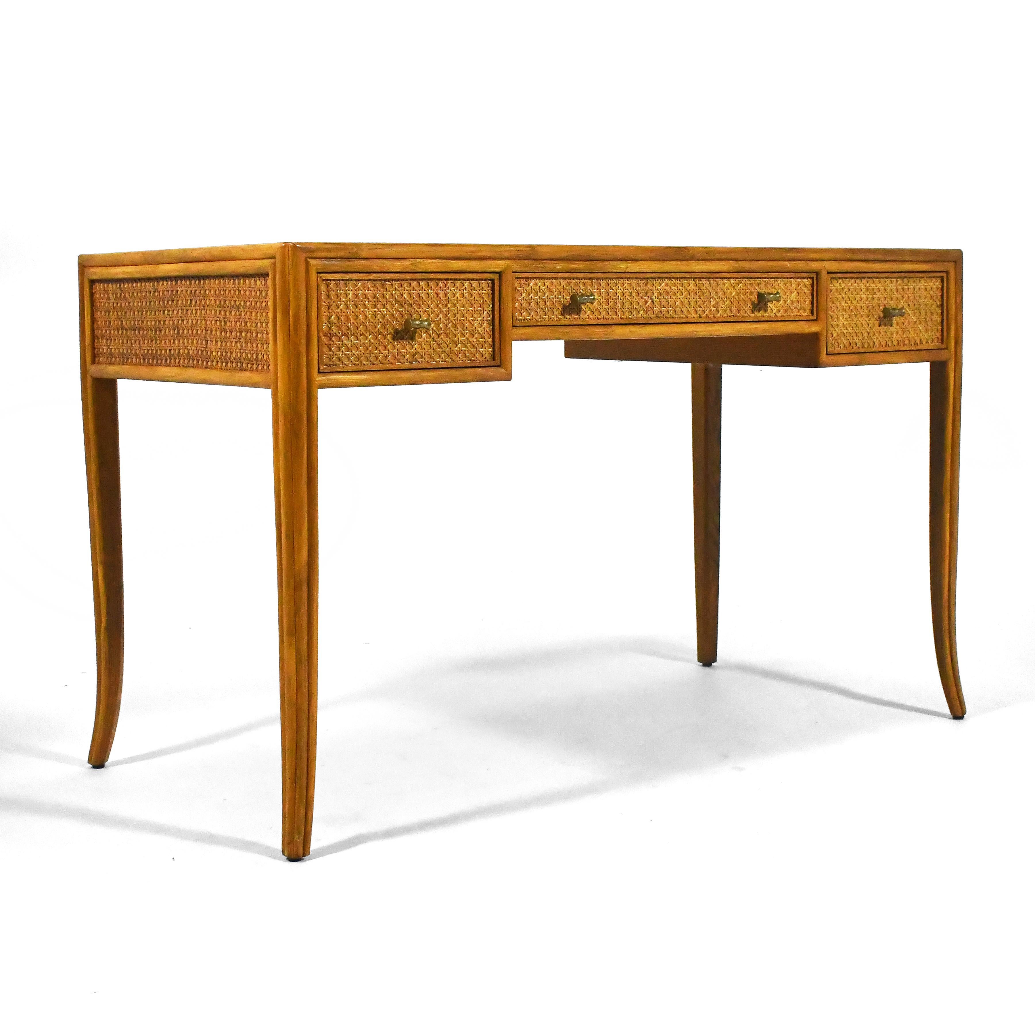 This exquisite design by Elinor McGuire for McGuire of San Fransisco is an exercise in subtle beauty and refined detailing. With a body covered in cane, slightly splayed legs, and solid brass bamboo-form pulls, the desk is expertly constructed and