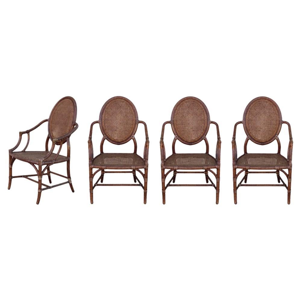 Elinor McGuire Rattan Cane Oval Back Dining Arm Chairs, a Set of Four For Sale