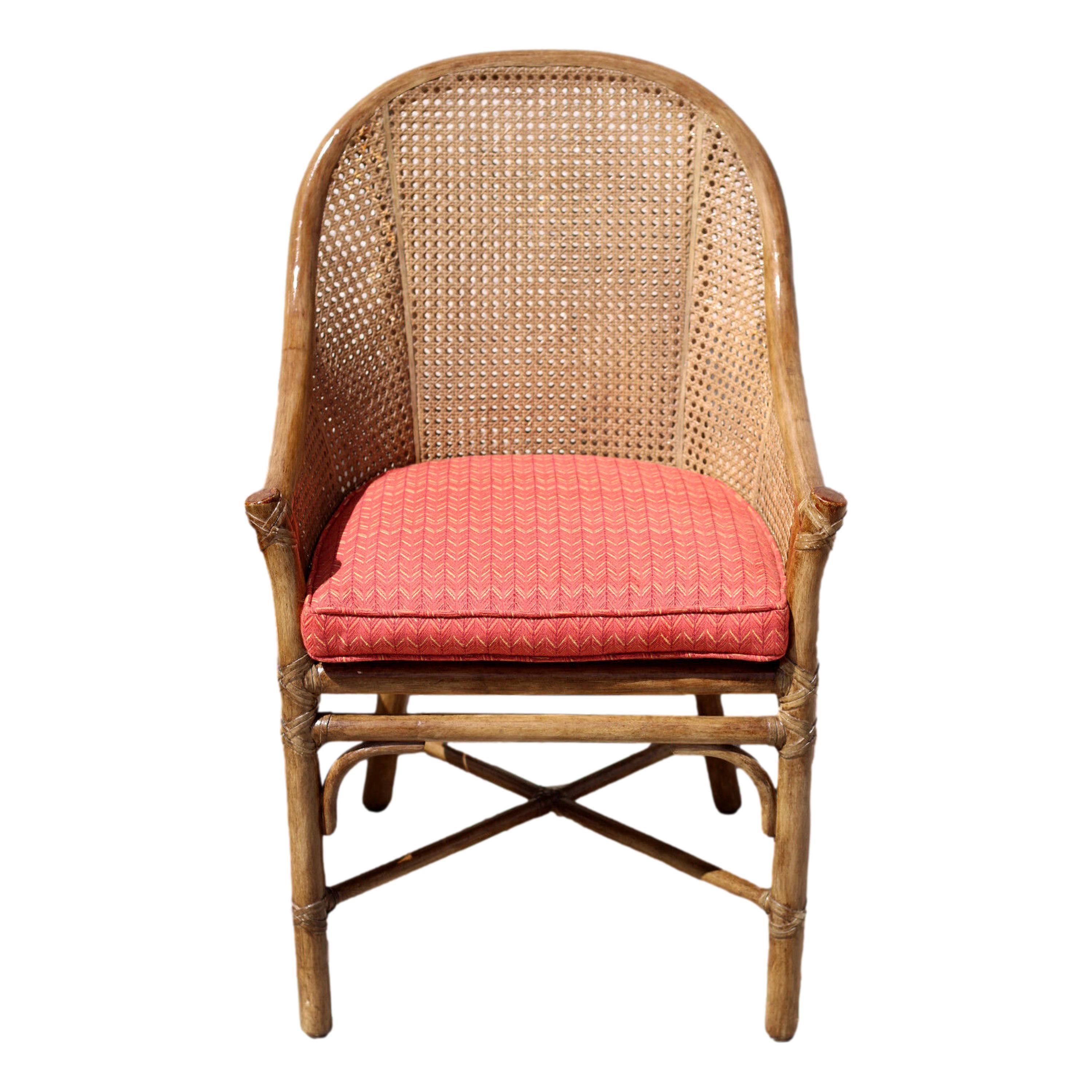 A pair of rattan caned barrel back dining armchairs designed by breakthrough innovator Elinor McGuire. Casual luxury from McGuire San Francisco. Vintage organic modern chairs designed in the classic tradition using beautiful materials simply and