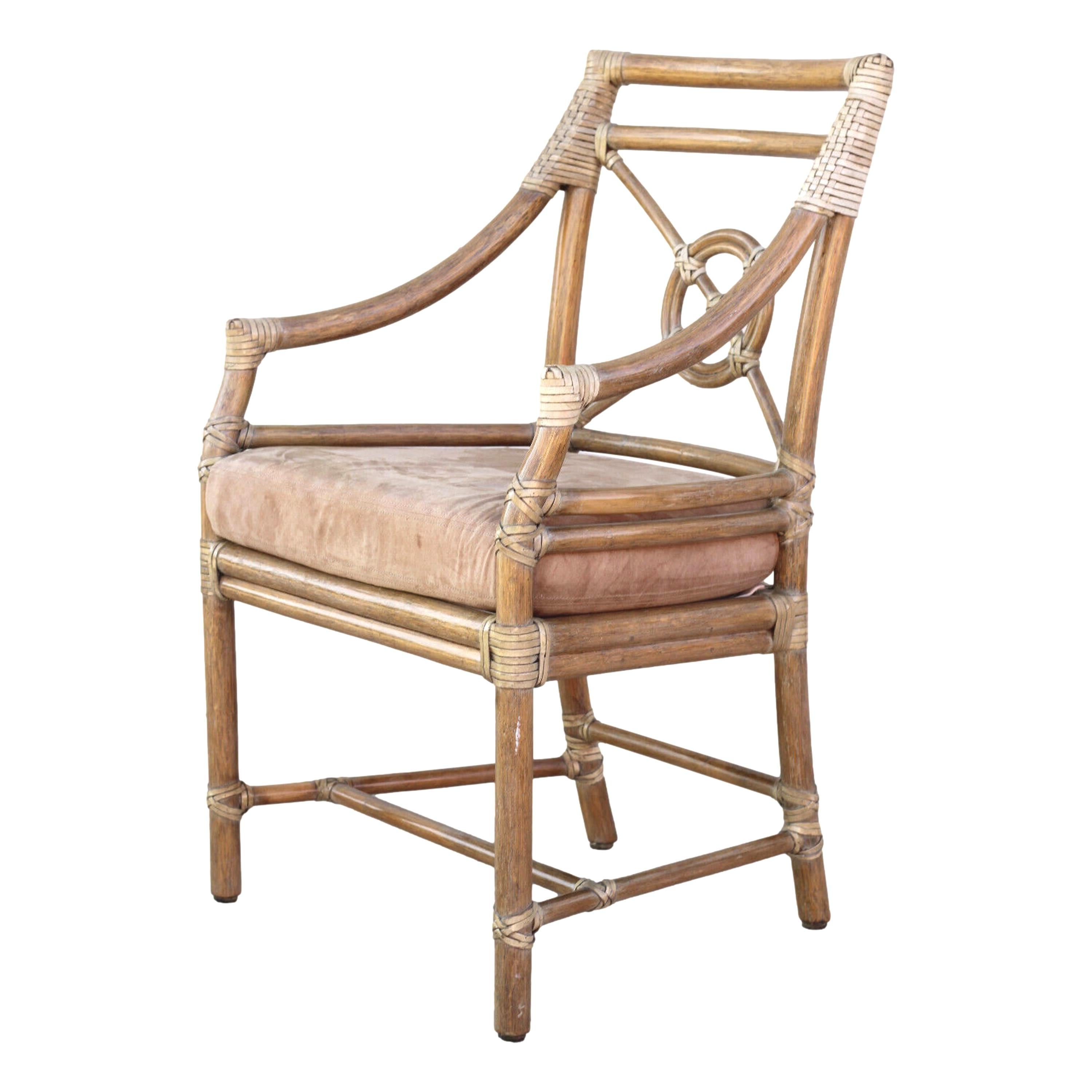 A beautiful set of six rattan arm chairs or dining chairs designed by breakthrough innovator Elinor McGuire in the California organic modern style. These impeccably crafted chairs display an open rattan back, which frames McGuire's iconic Rattan