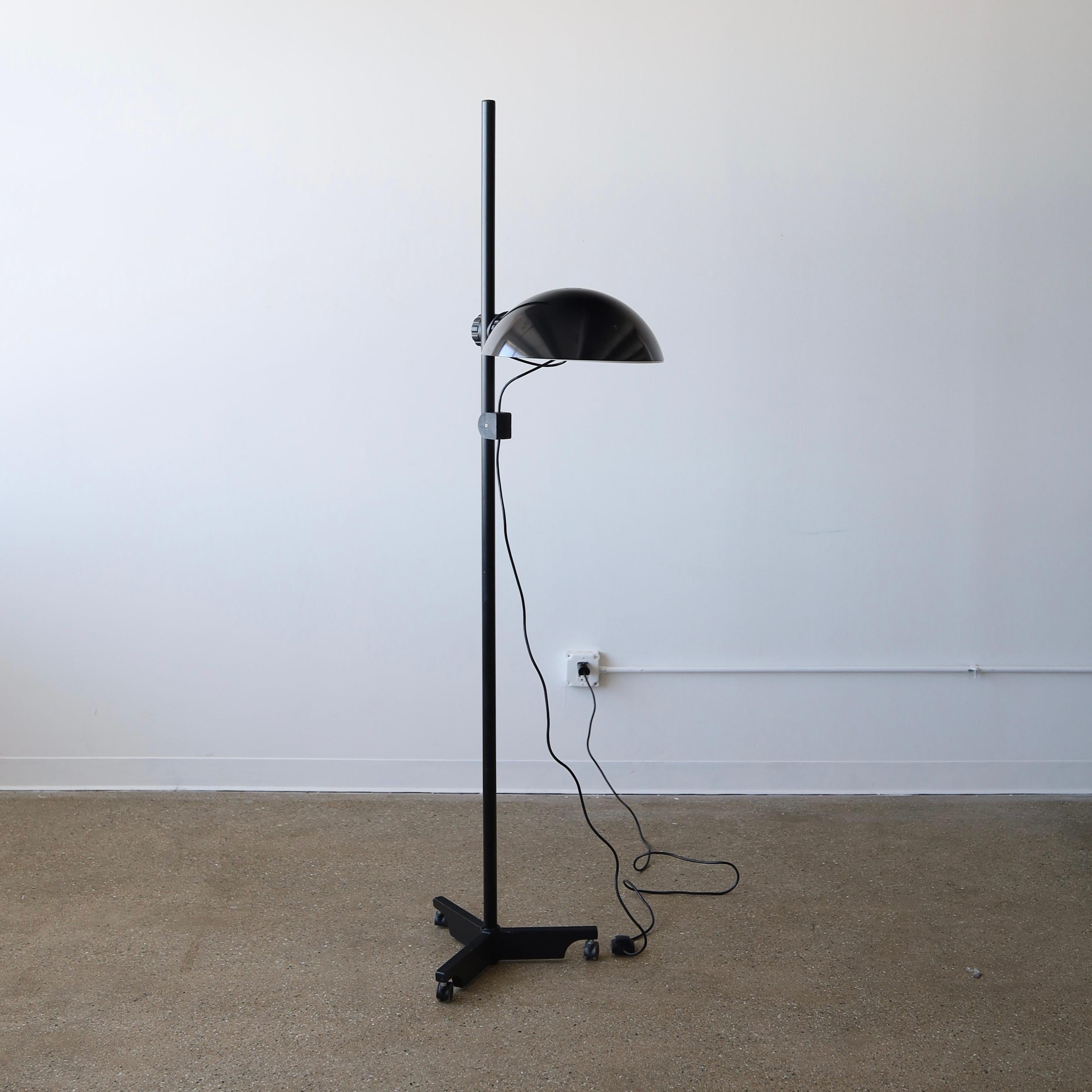 c. 1980s in great vintage condition. The shade is able to move up and down letting you change the height of the lighting source. There is wear present including light scratches, minor paint loss, and general scuffs. The wheels also work but require