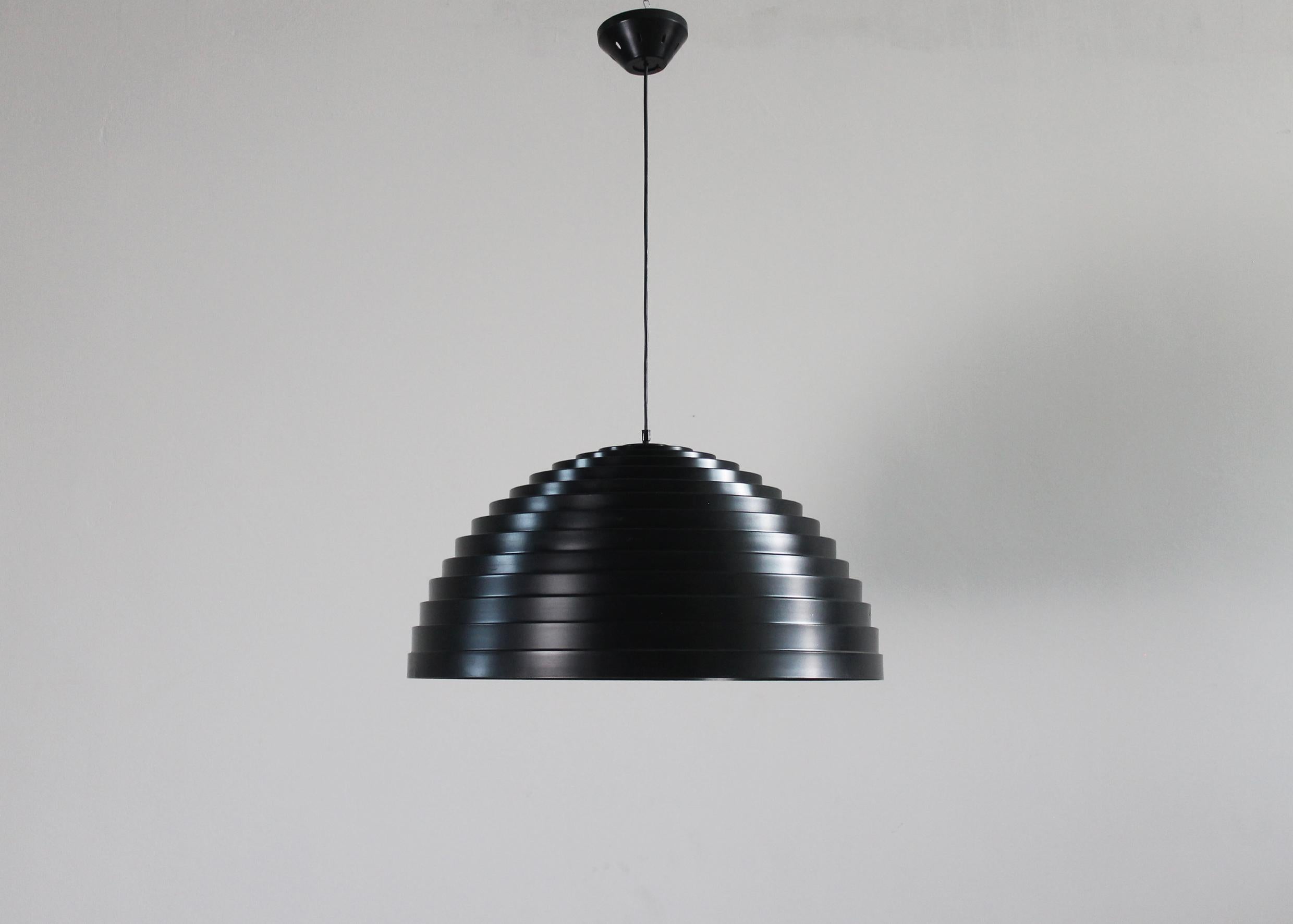 A rare ceiling lamp or chandelier (model Step) with a semisphere lampshade in black lacquered aluminum, it was designed by Elio Martinelli and produced by the Italian company, Martinelli Luce during the 1970s. 

The concentric shapes repeated in a