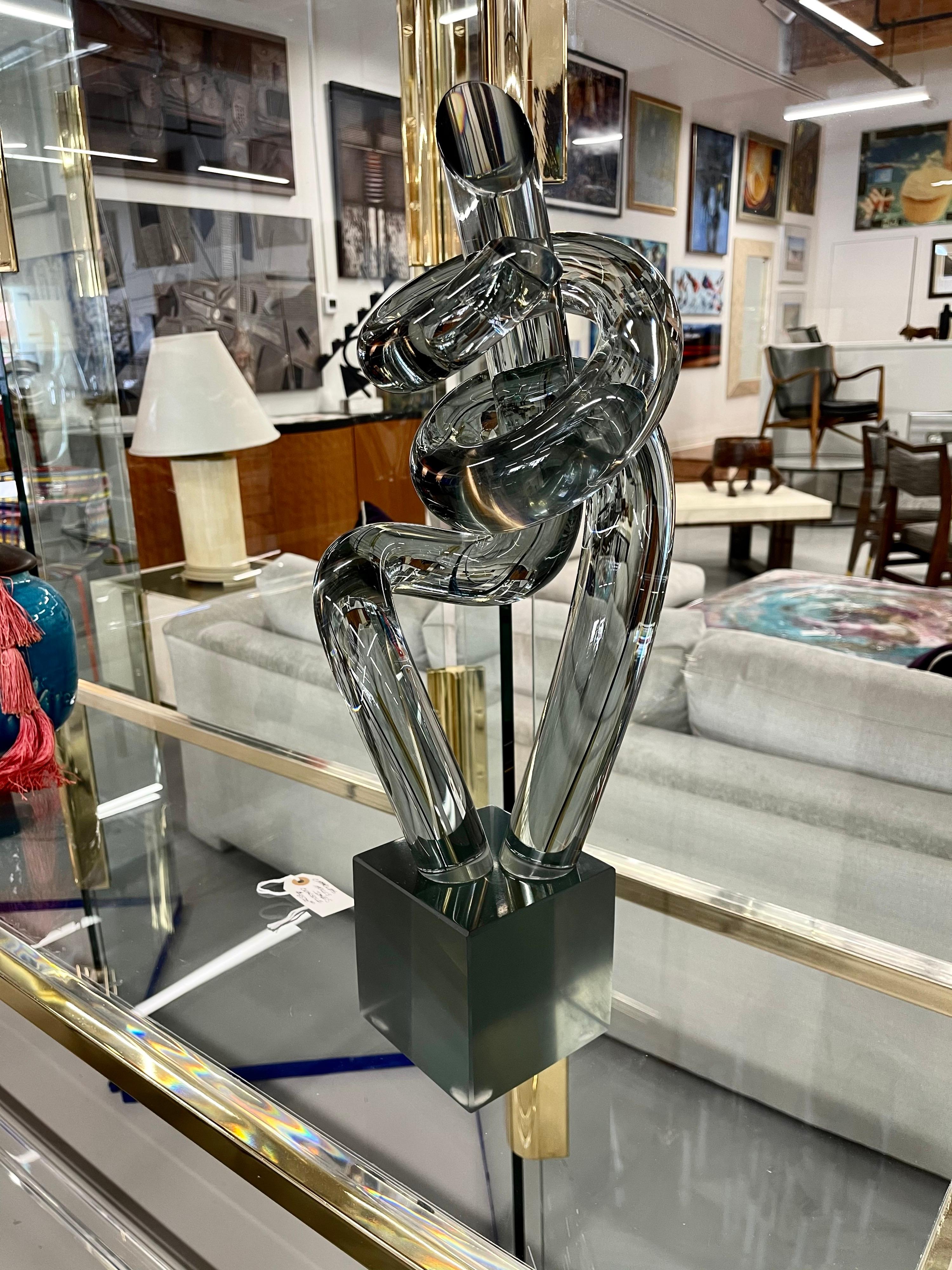 A wonderful smoked glass twisted sculpture by the Italian Master Elio Raffaeli. Approximately 21 inches tall. In good age appropriate condition, with some minor marks on the base.