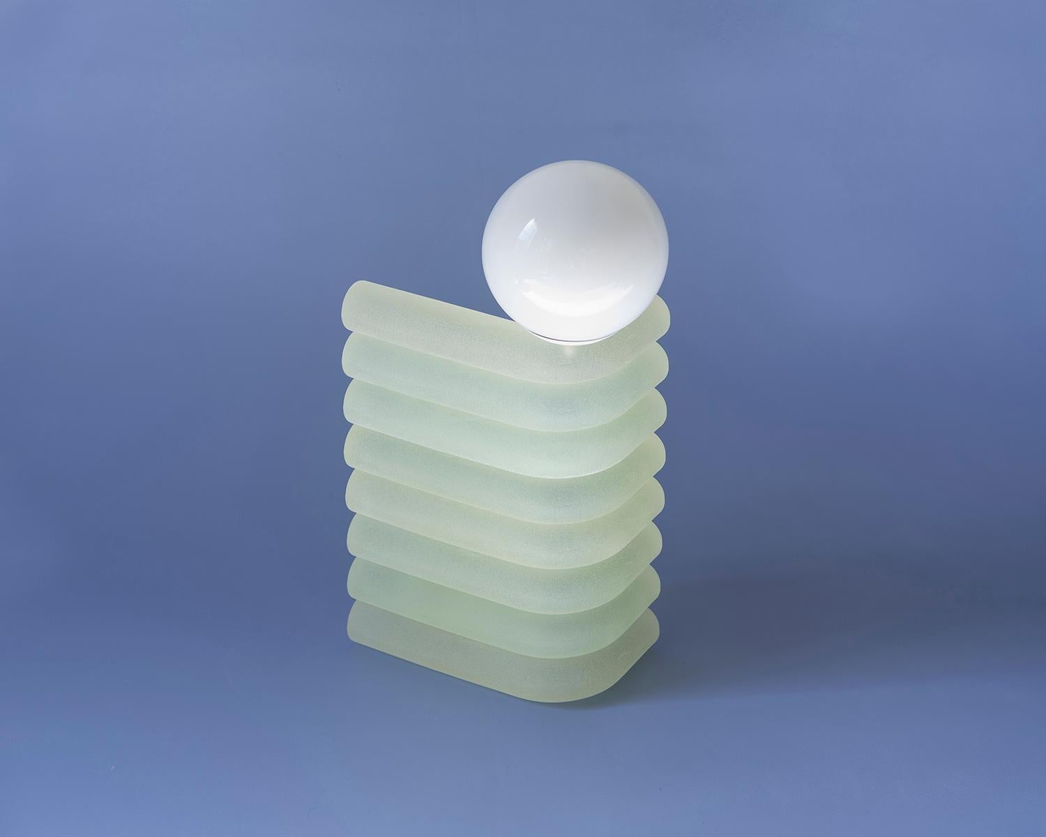 Elio lamps are stacks of translucent, tubular cast-resin that create a diffused glow, with frosted sugar jellies as a visual reference. The lamp's singular bend is a small ode to Eileen Gray’s Bibendum lounge. Integrated with smart wifi devices,