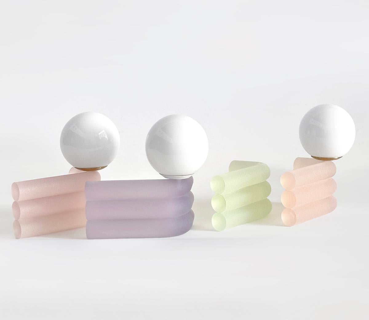 Elio lamps are stacks of translucent, tubular cast-resin that create a diffused glow, with frosted sugar jellies as a visual reference. The lamp's singular bend is a small ode to Eileen Gray’s Bibendum lounge. Integrated with smart wifi devices,