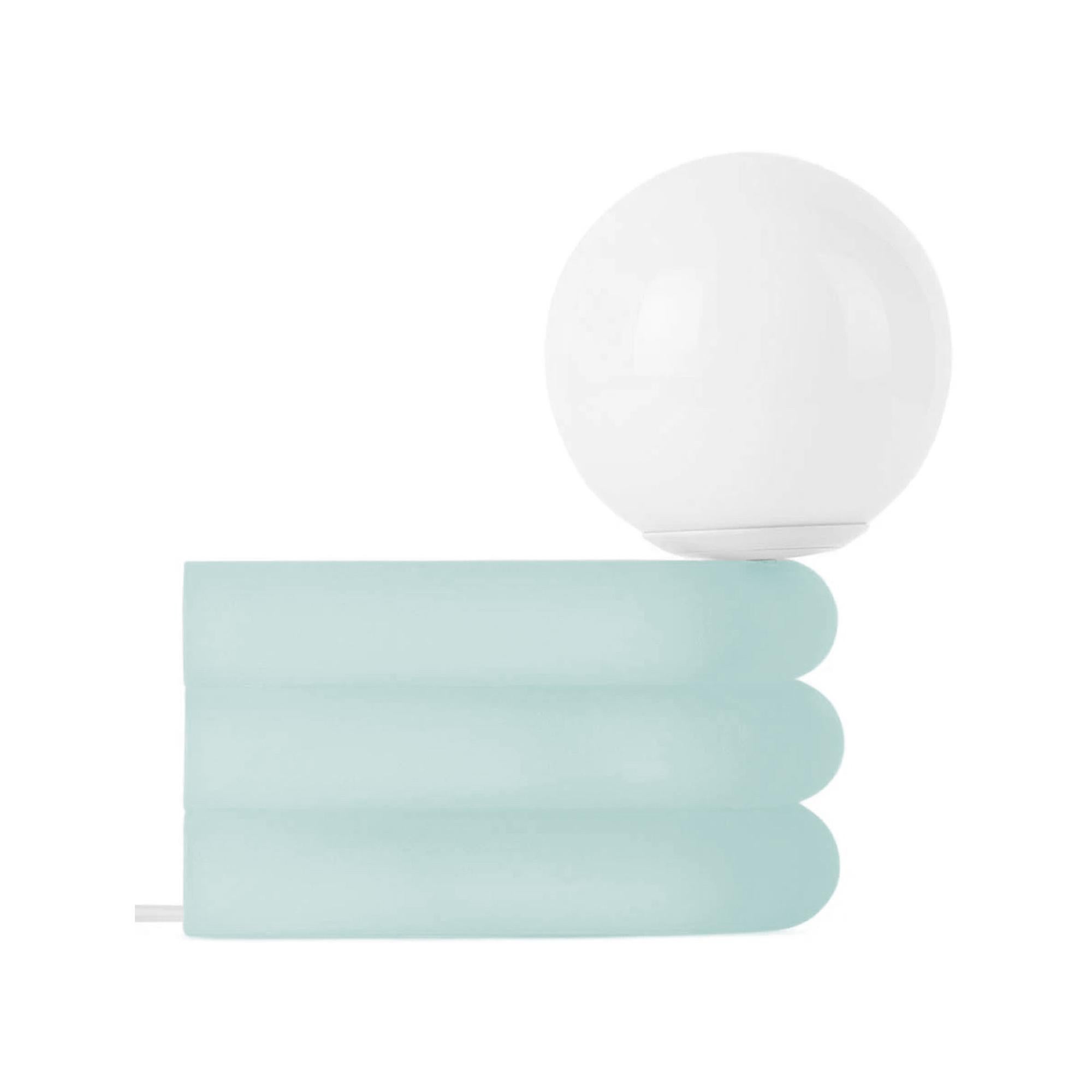 Elio lamps are stacks of translucent, tubular cast-resin that create a diffused glow, with frosted sugar jellies as a visual reference. The lamp's singular bend is a small ode to Eileen Gray’s Bibendum lounge. Integrated with smart wifi devices,