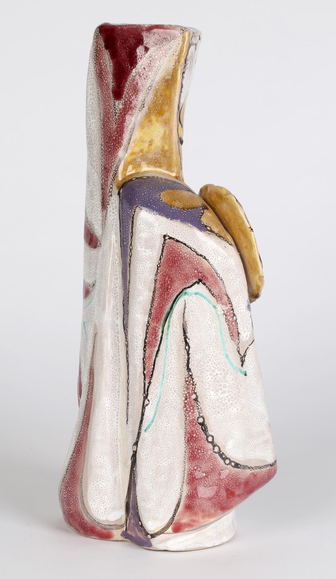 A large and stunning Italian hand painted abstract figurative sculptural 'Guerriero' (warrior or fighter) ceramic vase by Elio Schiavon (1925-2004) dating from around 1960. This very stylized hand crafted vase portrays a figure holding a shield and