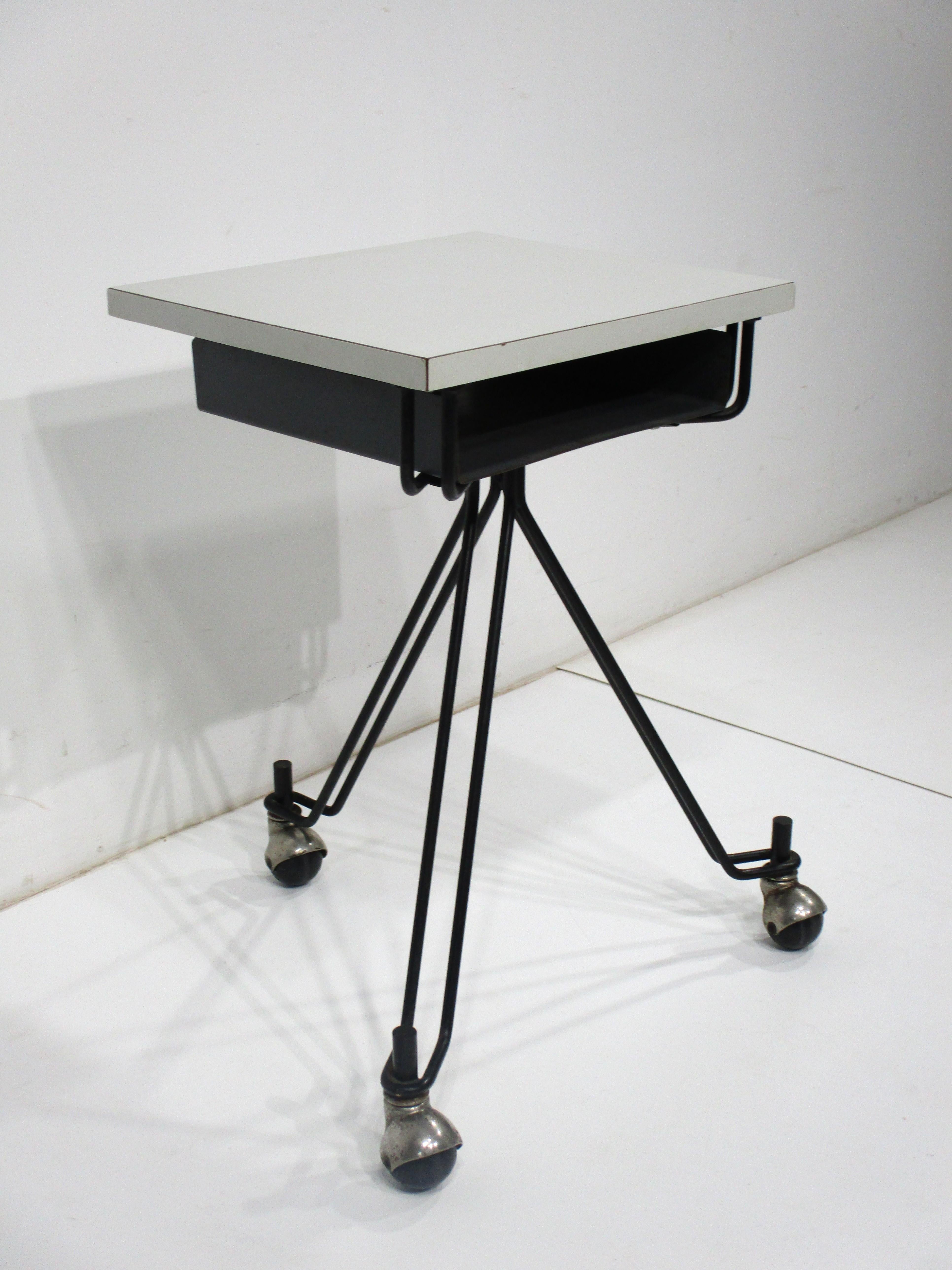 A classic Mid Century industrial form , a rolling small scale telephone , dictating machine desk table . Manufactured by IBM for in office use when you needed a portable work surface , a great piece that can be used for a laptop , cell phone or