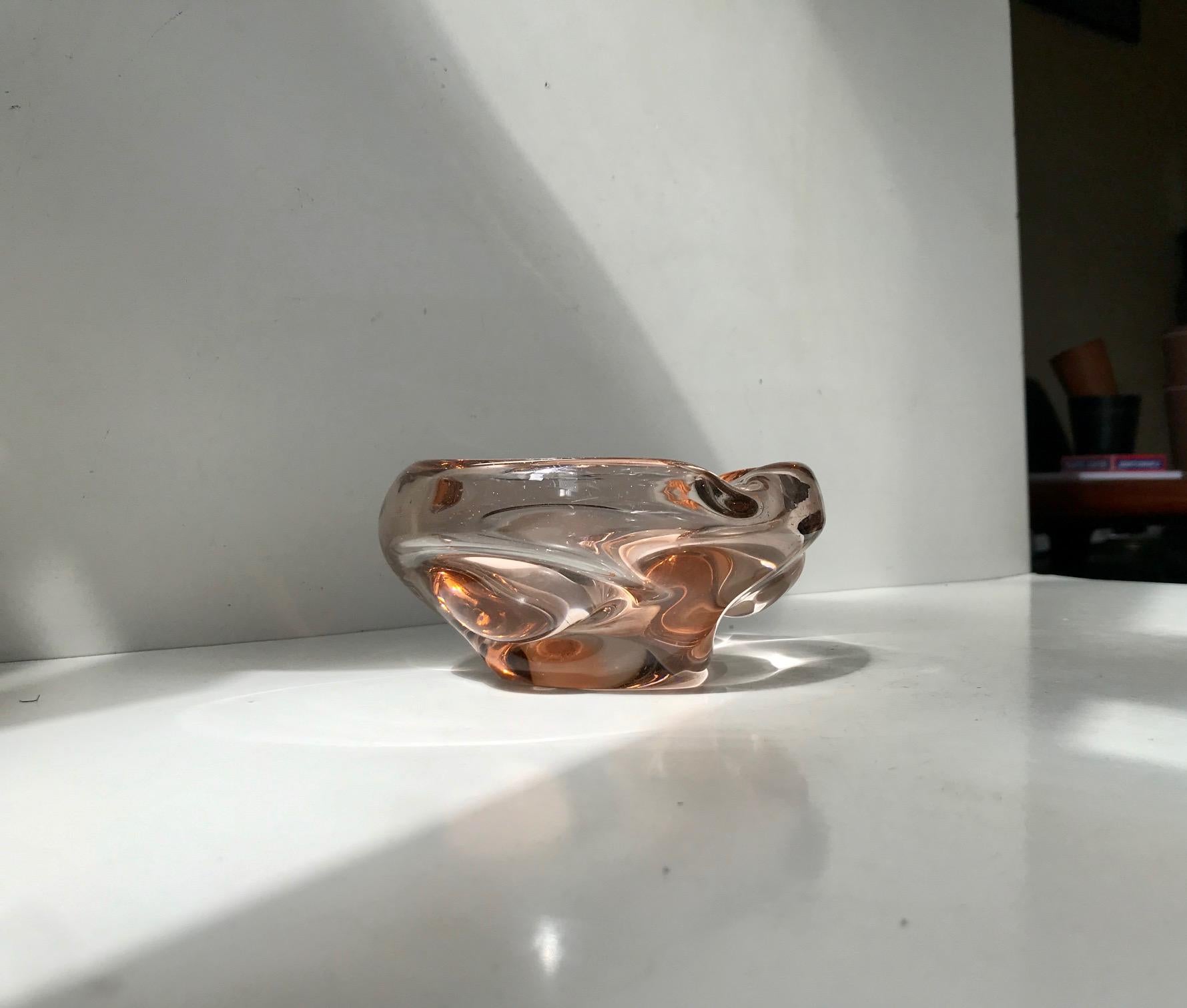 Salmon colored dish or ashtray in submerged/partially collapsed handblown 'Salmon' or Rose glass. Designed by Elis Bergh and manufactured by Kosta Boda in Sweden circa 1930-40. We have not been able to find any markings on its scratches base.