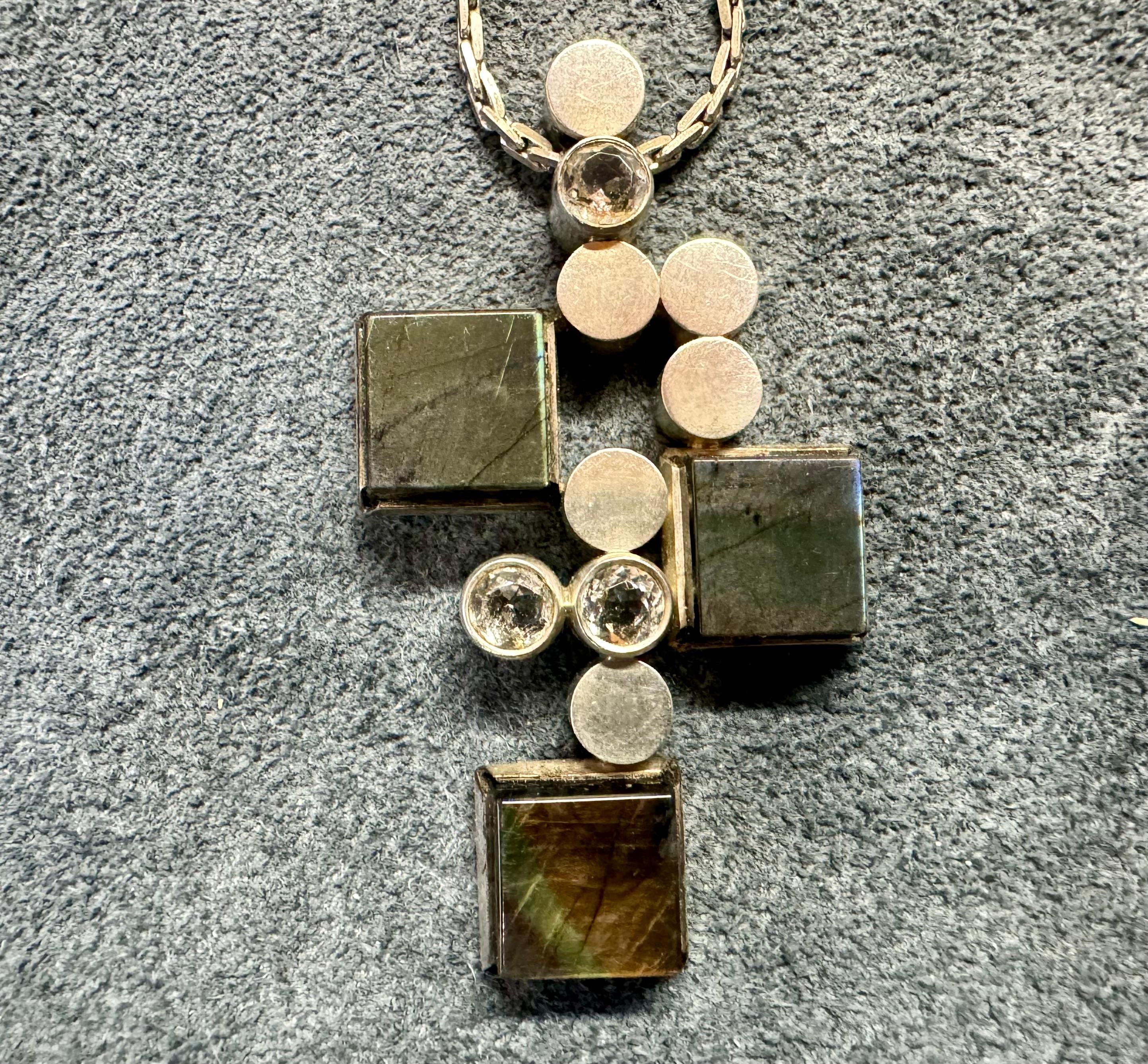 Elis Kauppi for Kupittaan Kulta Oy Silver Necklace Made 1965.
Spectrolite and Synthetic Spinel
Chein 38cm
813H Silver.
Made in Turku Finland.

I also have a Braclet from the same series for sale