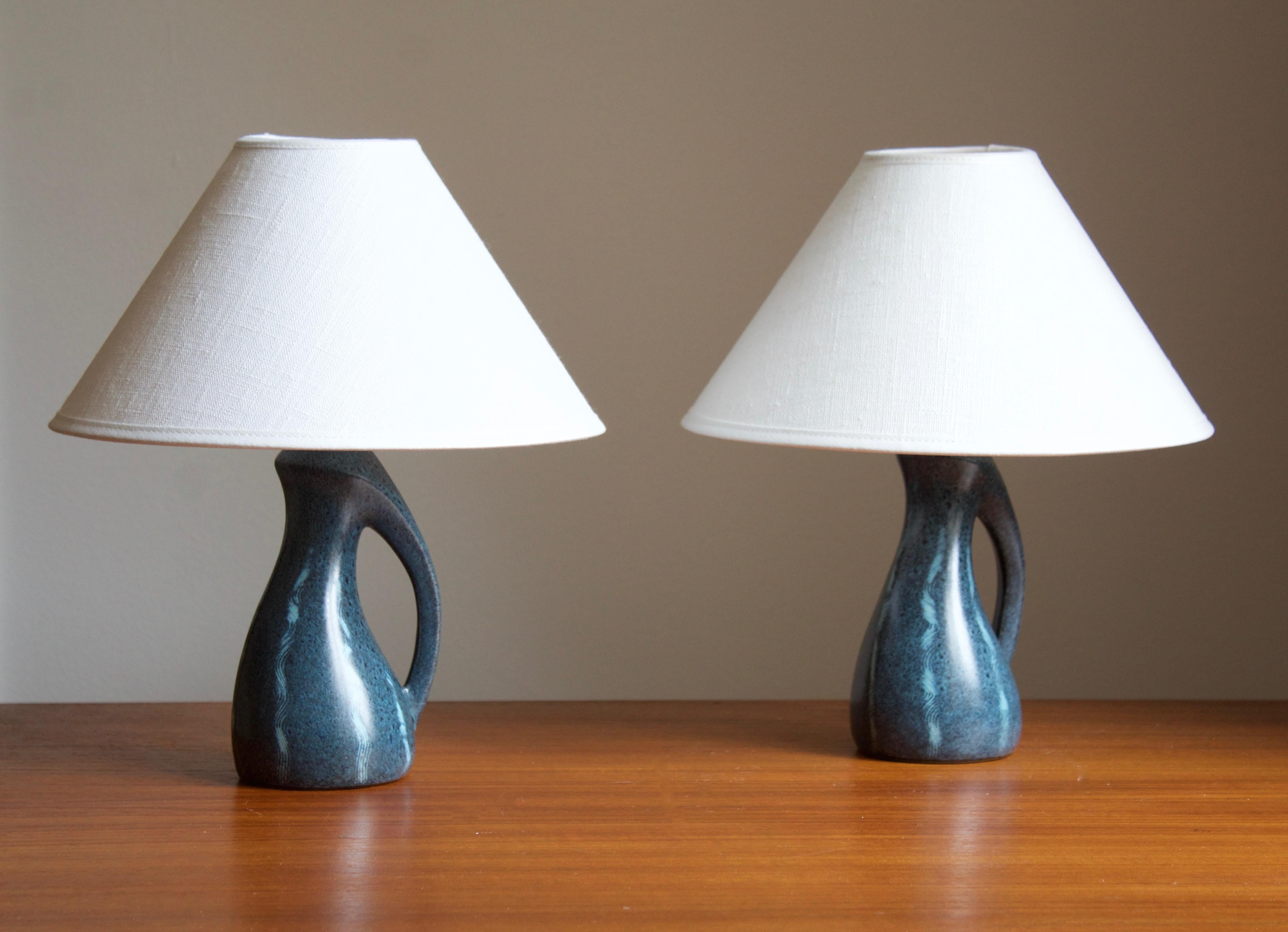 A pair of organic table lamps, made by Elisabeth Loholt, in her own studio, Loholt Keramik. Denmark, 1950s.

Stated dimensions exclude lampshades. Height includes socket. Sold without lampshades.

Features a finely ornamented blue glaze.