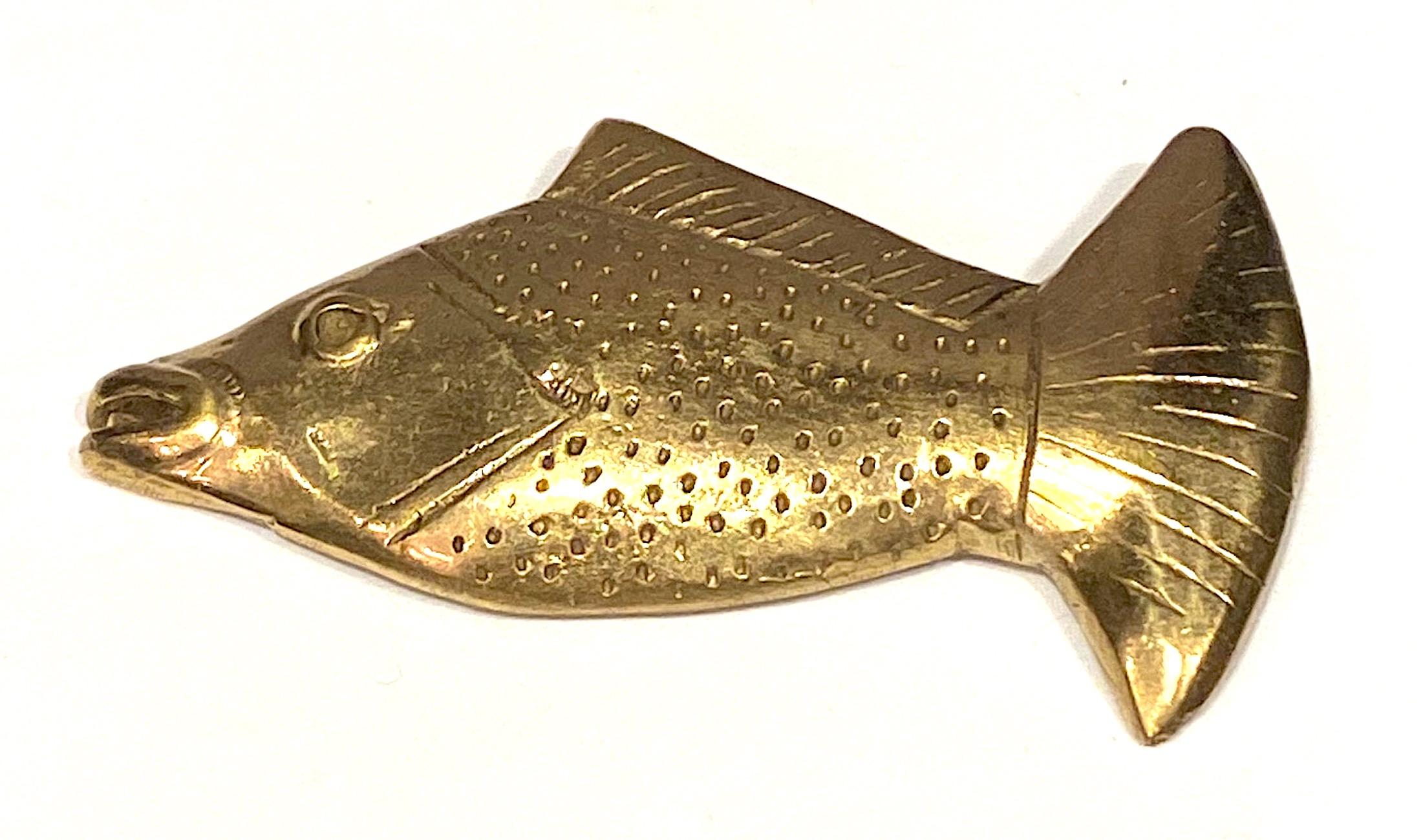 Elisabeth Riveiro of Paris cast bronze fish brooch. Riveiro jewelry is designed and hand made in France using lost wax casting, etching  and chiselling methods to enhance their ancient and hand made quality. The fish brooch measures 2.5 inches wide,