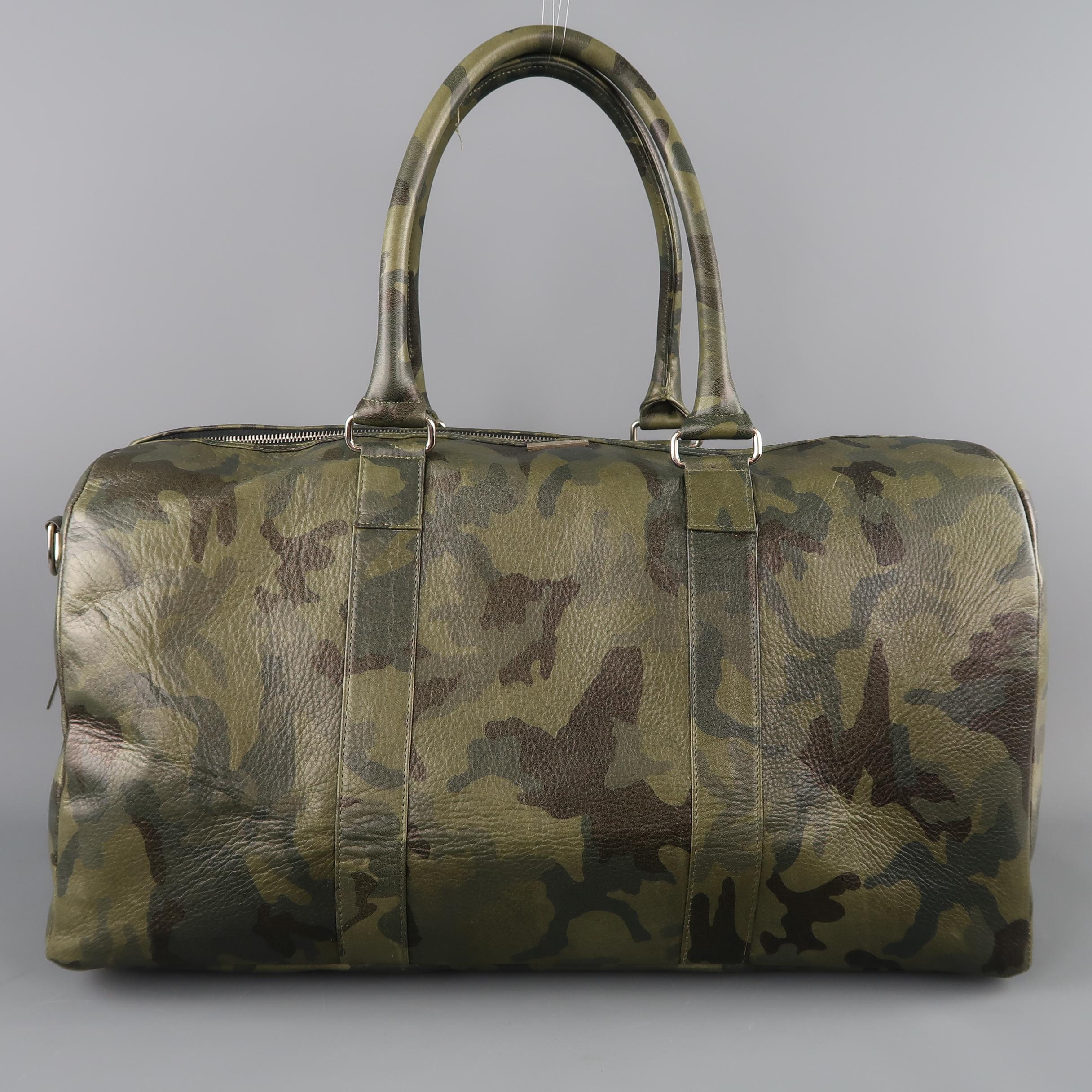 ELIZABETH WEINSTOCK travel weekender bag comes in green camouflage print leather with double wrapped top handles, silver tone hardware, and top zip closure. Detachable shoulder strap included. Made in USA. Retail price $ 1,595.00. 
 
Excellent