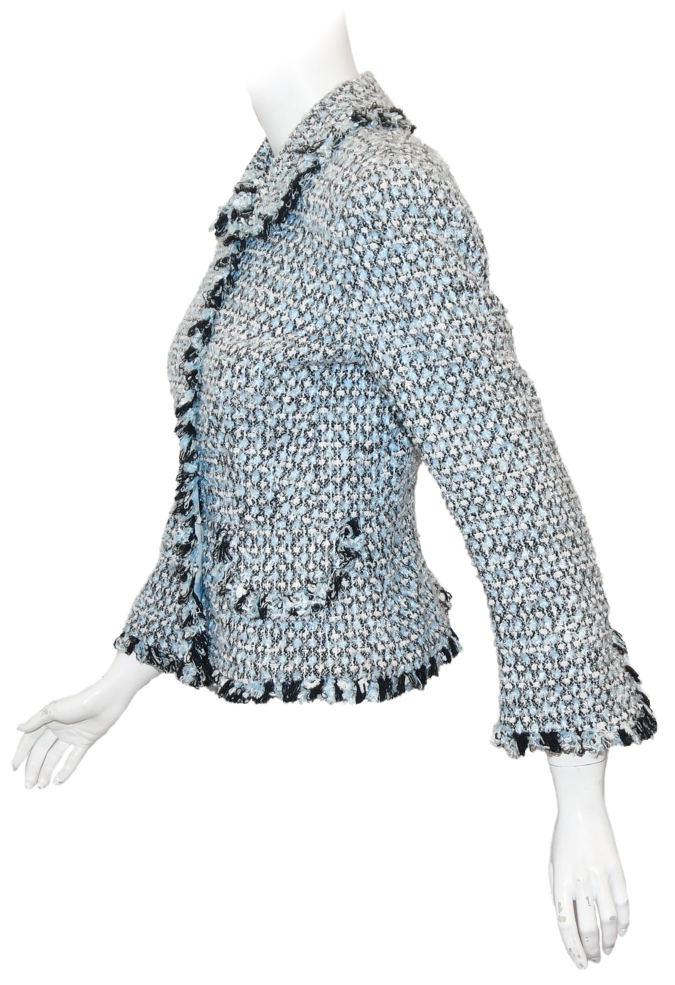Escada blue tweed jacket incorporates a fringe shirt collar and fringe cuffs.  This jacket is lightweight and can be worn to the office and  easily flows into the night.  It can be paired with a skirt, slacks or, even, a dress,  This pale blue mix