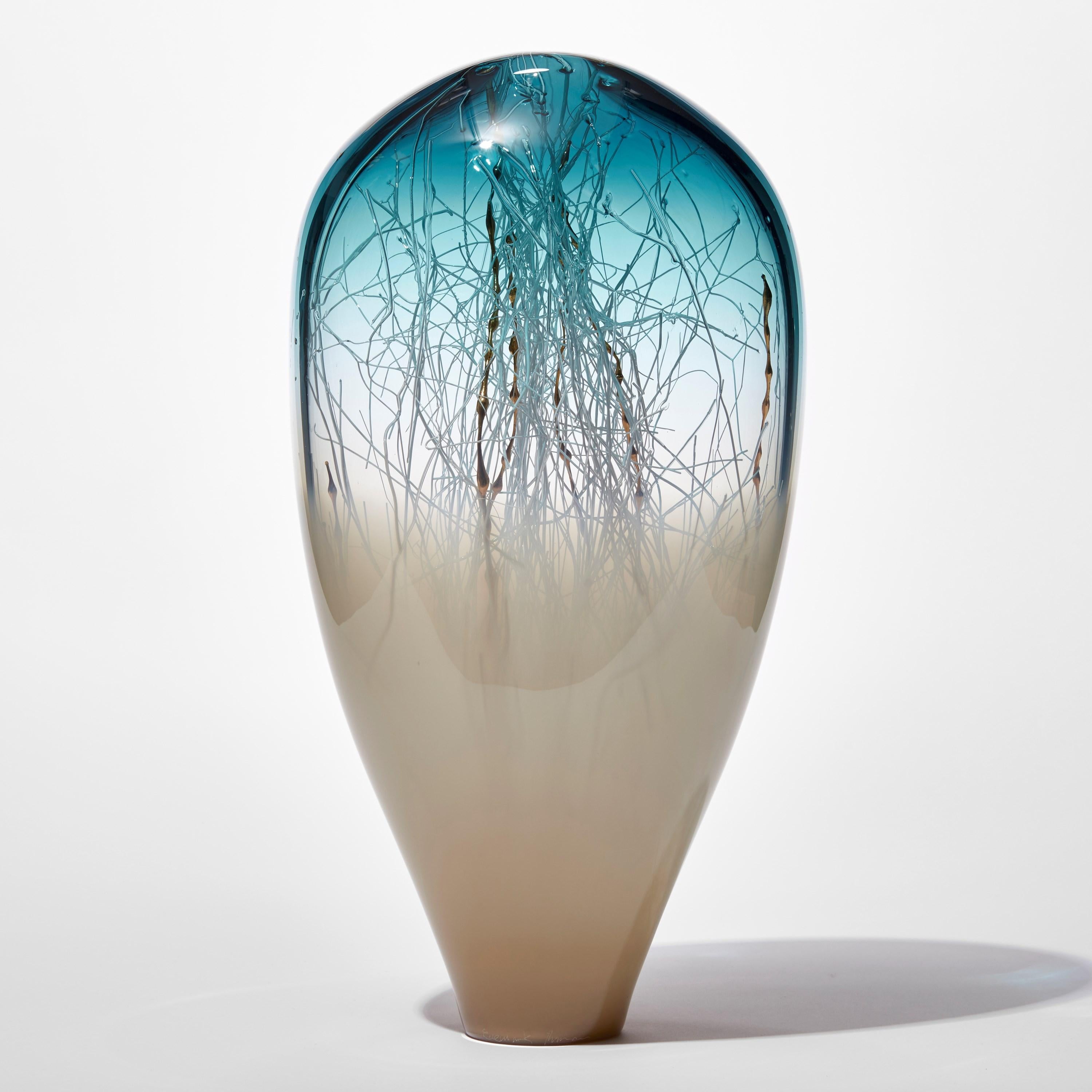 'Elixir in Weimaraner and Ocean Blue' is a unique handblown and sculpted glass artwork by the Danish and British artists, Hanne Enemark & Louis Thompson.

The outer glass form contains a multitude of fine white canes of glass, some of which have