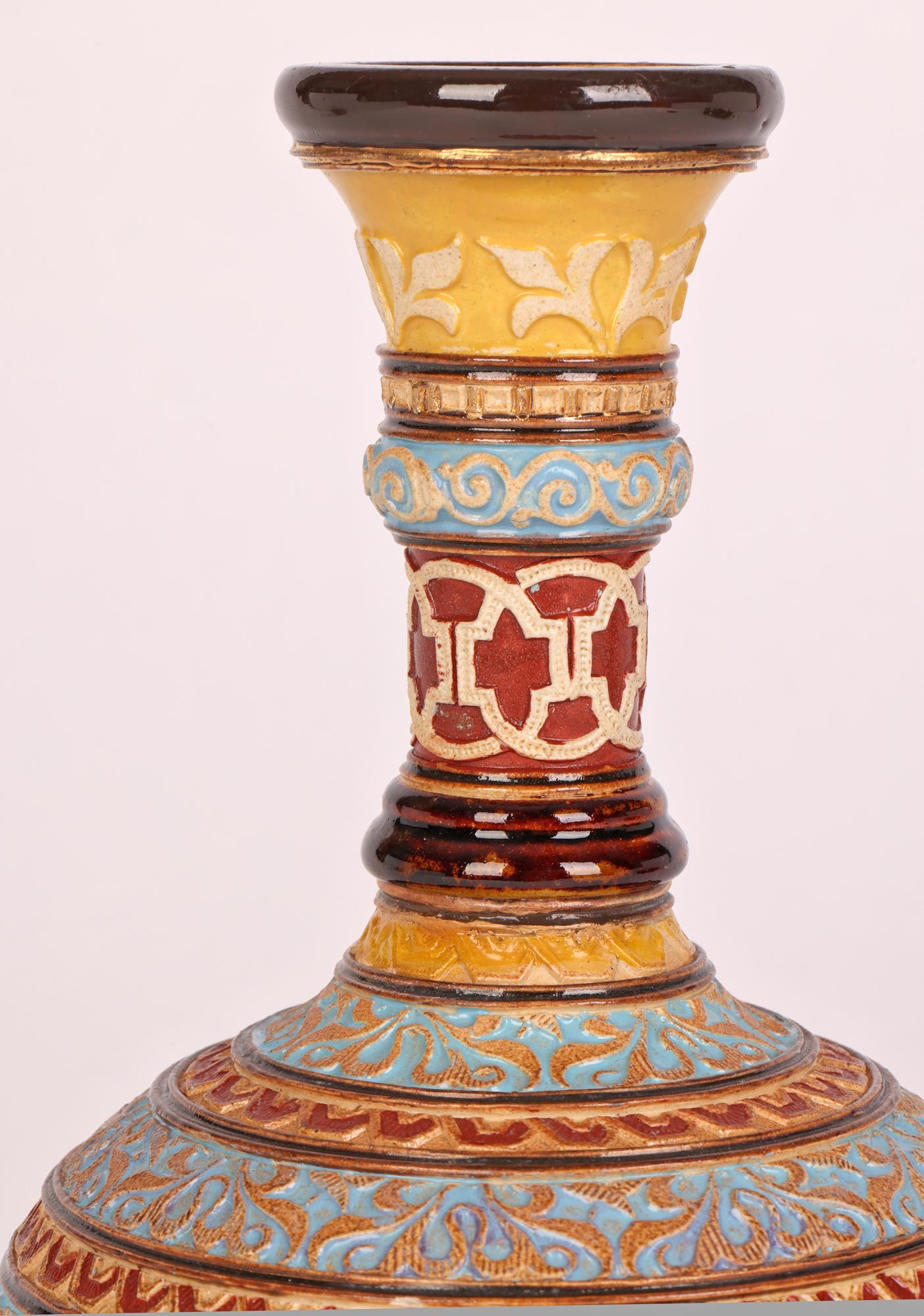 A very unusual Doulton Lambeth Aesthetic Movement stoneware vase decorated in low relief in Persian style by renowned and sought after artist Eliza Simmance dating from around 1885. The vase stands on a narrow round pedestal foot with a wide round