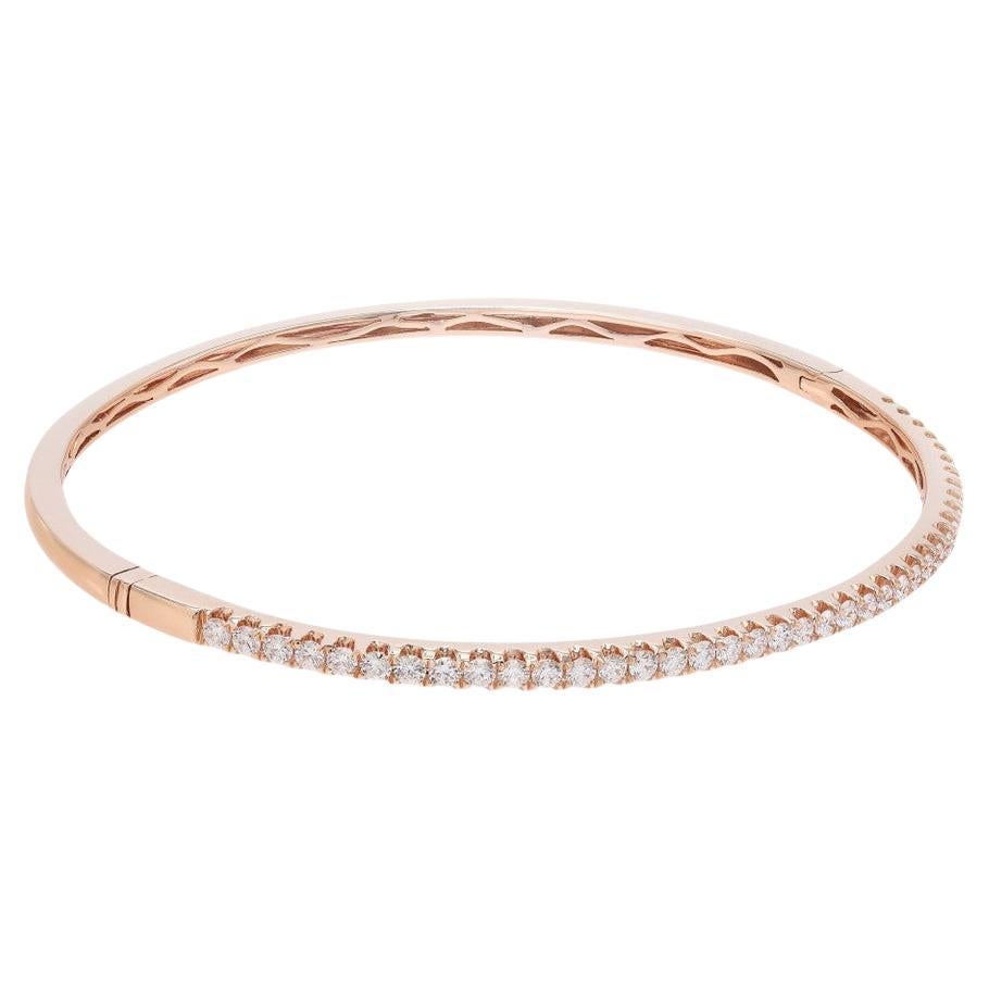 Experience the epitome of elegance with this stunning Diamond Bangle Bracelet. Crafted in exquisite 18K rose gold, it exudes a luxurious and feminine allure. Adorned with a mesmerizing arrangement of diamonds, totaling 0.99 carats, this bracelet