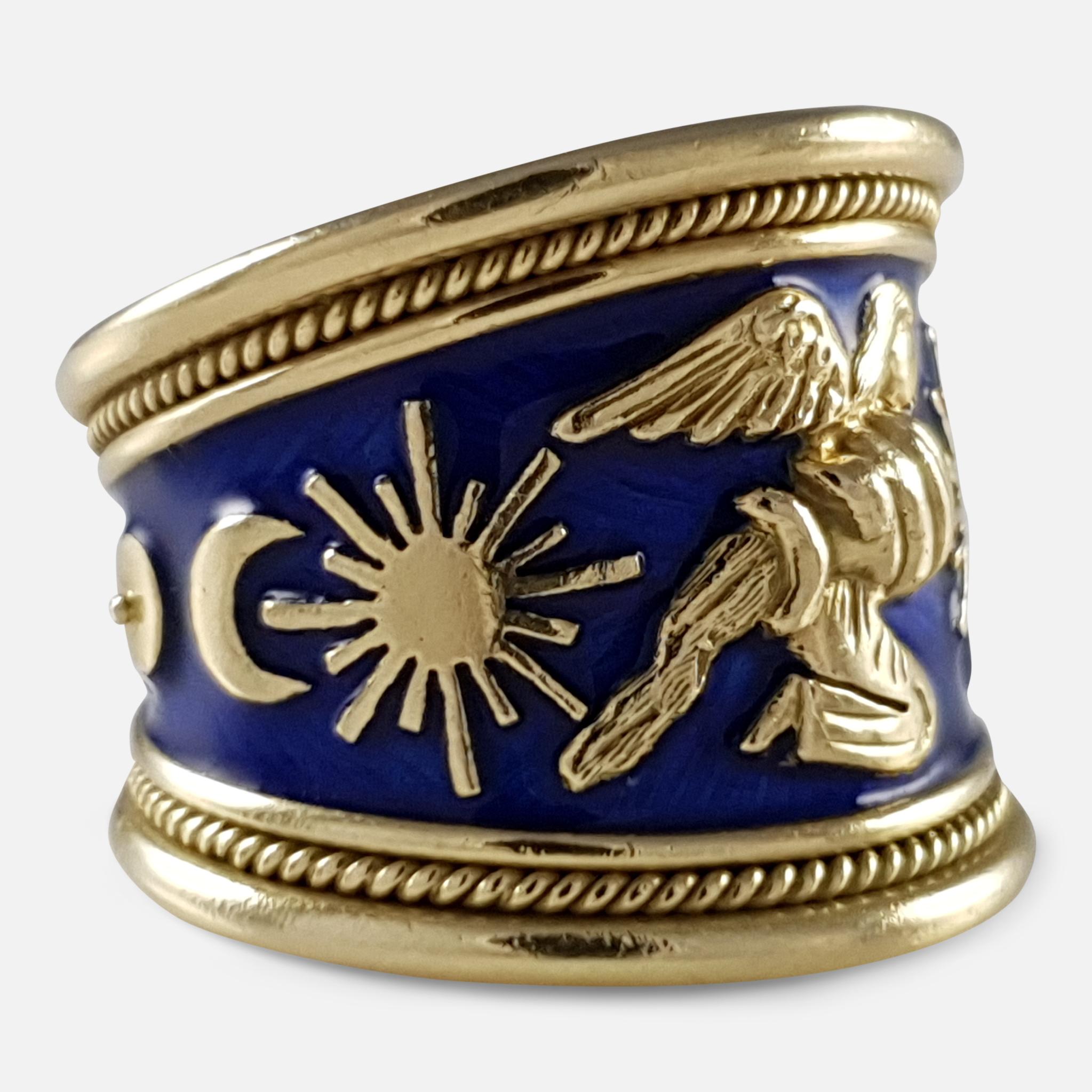 Description: - A superb Elizabeth Gage 18 karat yellow gold and blue enamel tapered Zodiac ring featuring the Aquarius motif and decorated with the sun and moon motifs and the planets Venus and Mercury.  The ring is finished with gold bead detail