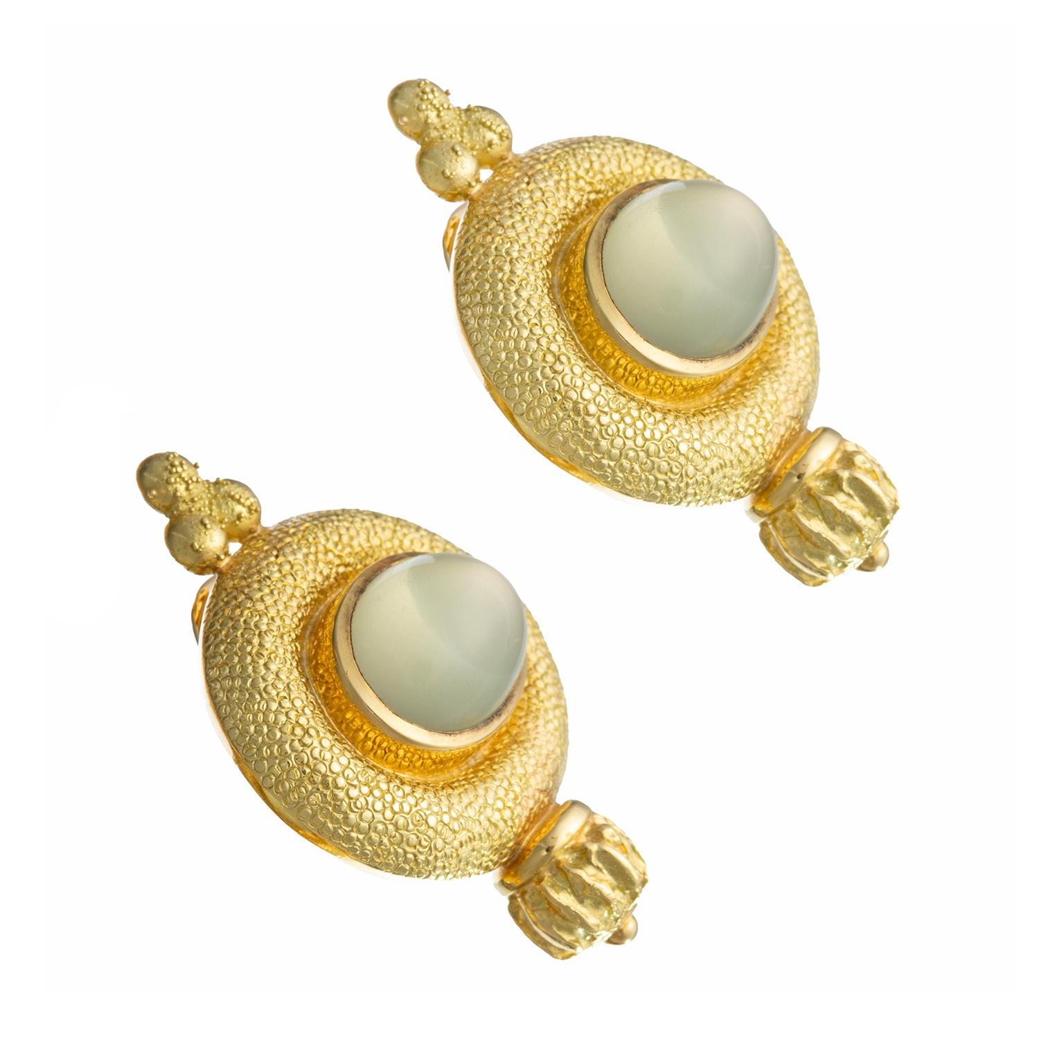 London-based designer Elizabeth Gage clip earrings in hammered 18k yellow gold each centering a bezel-set 15 x 10mm cabochon-cut prasiolite with a crown motif at the bottom.  Signed 'GAGE' 'EG 750' © with English makers' marks.  Earring dimensions: