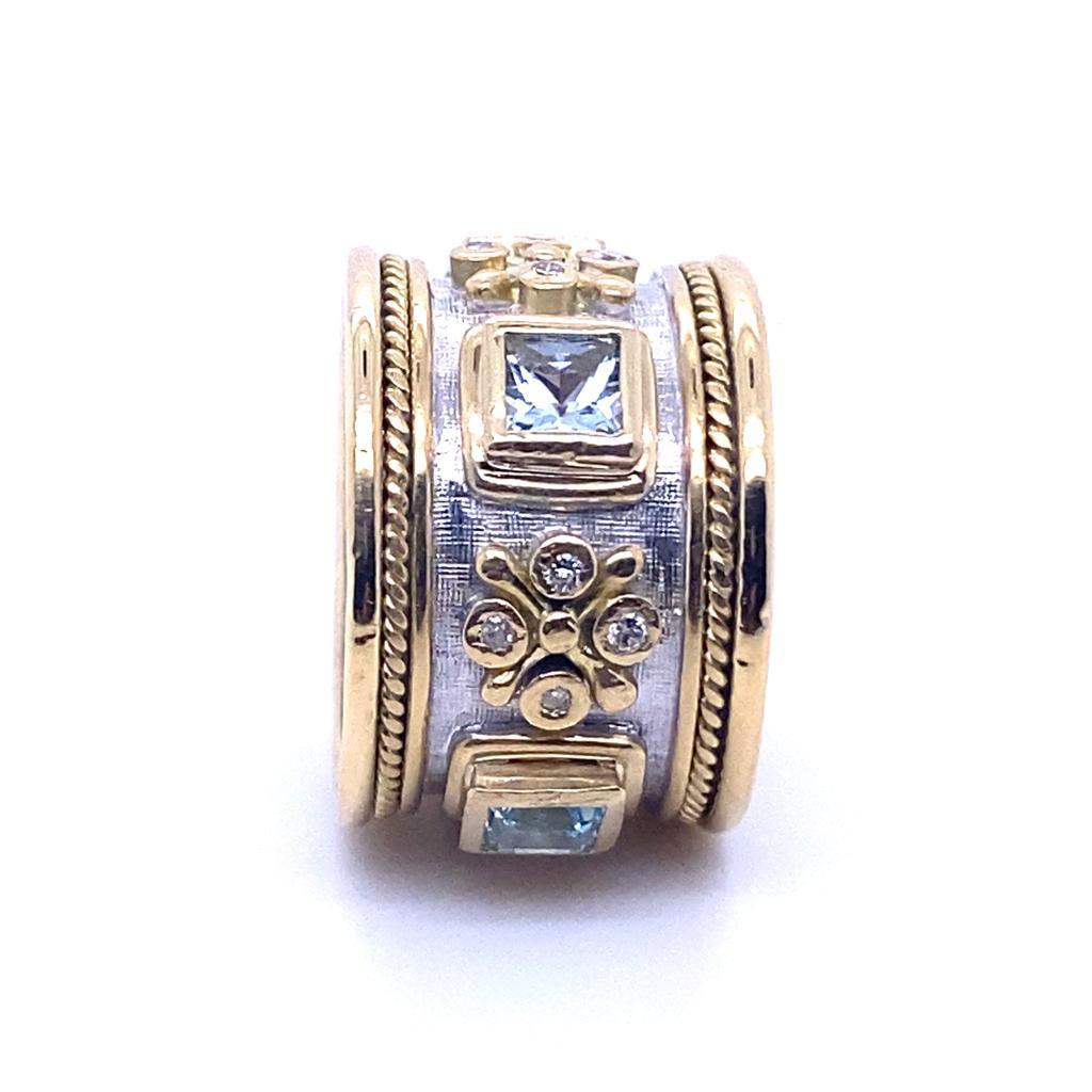 An Elizabeth Gage aquamarine and diamond 18 karat yellow and white gold Templar ring, circa 1990.

This Byzantine style Templar ring is designed as four French cut aquamarines alternating with groups of four bezel set round brilliant cut diamonds