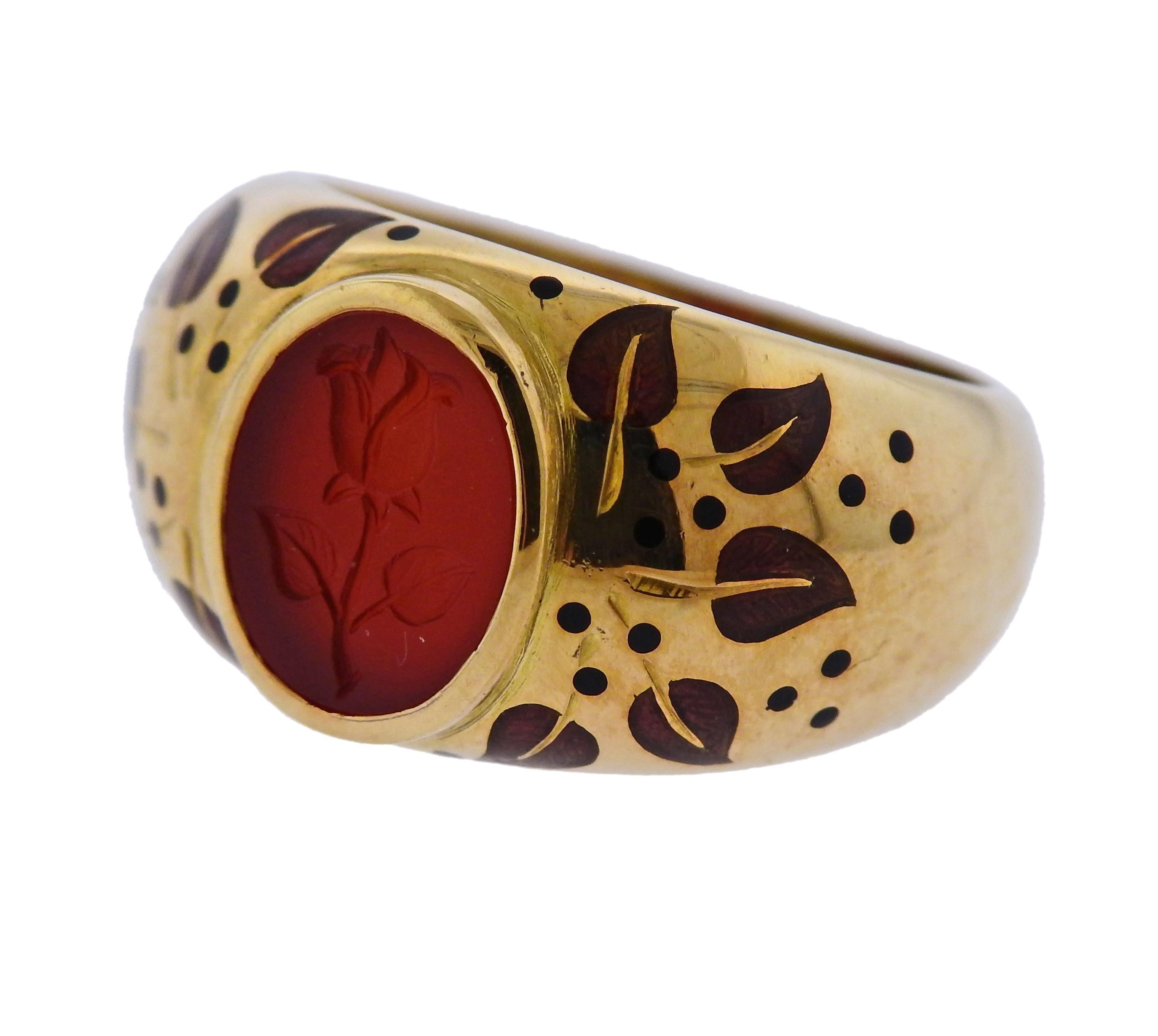 18k yellow gold ring by Elizabeth Gage, decorated with carnelian intaglio, and enamel leaves. Ring size 6, ring top is 12.5mm wide and weighs 10.1 grams. Marked Gage, English gold assay marks.