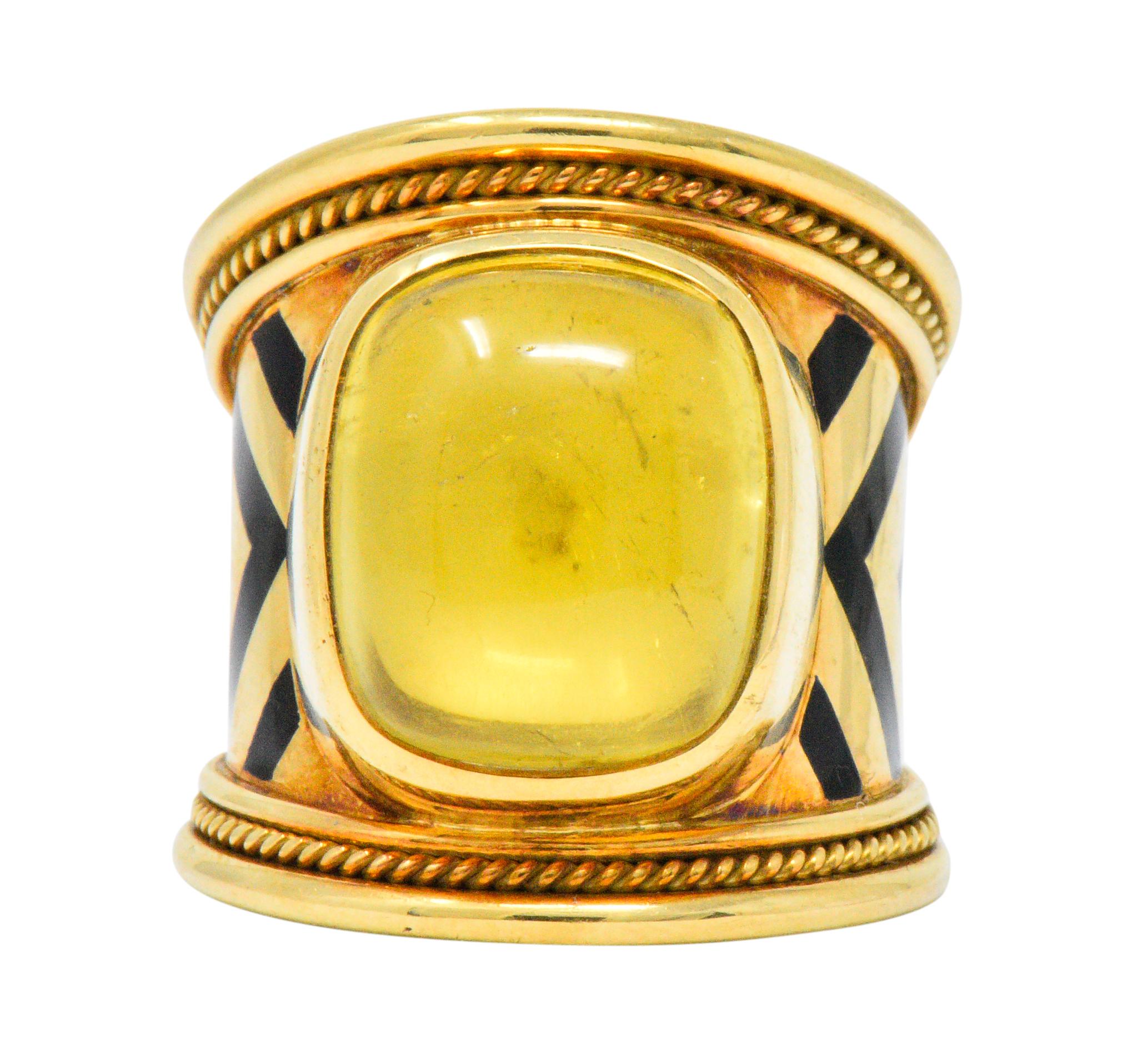 Centering a bezel set, rectangular buff-top citrine, backed with mother of pearl, measuring approximately 14.5 x 12.5 mm, bright sunny yellow

Black enamel chevron inlay with twisted gold detail

Signed Gage with maker's mark for Elizabeth Gage and