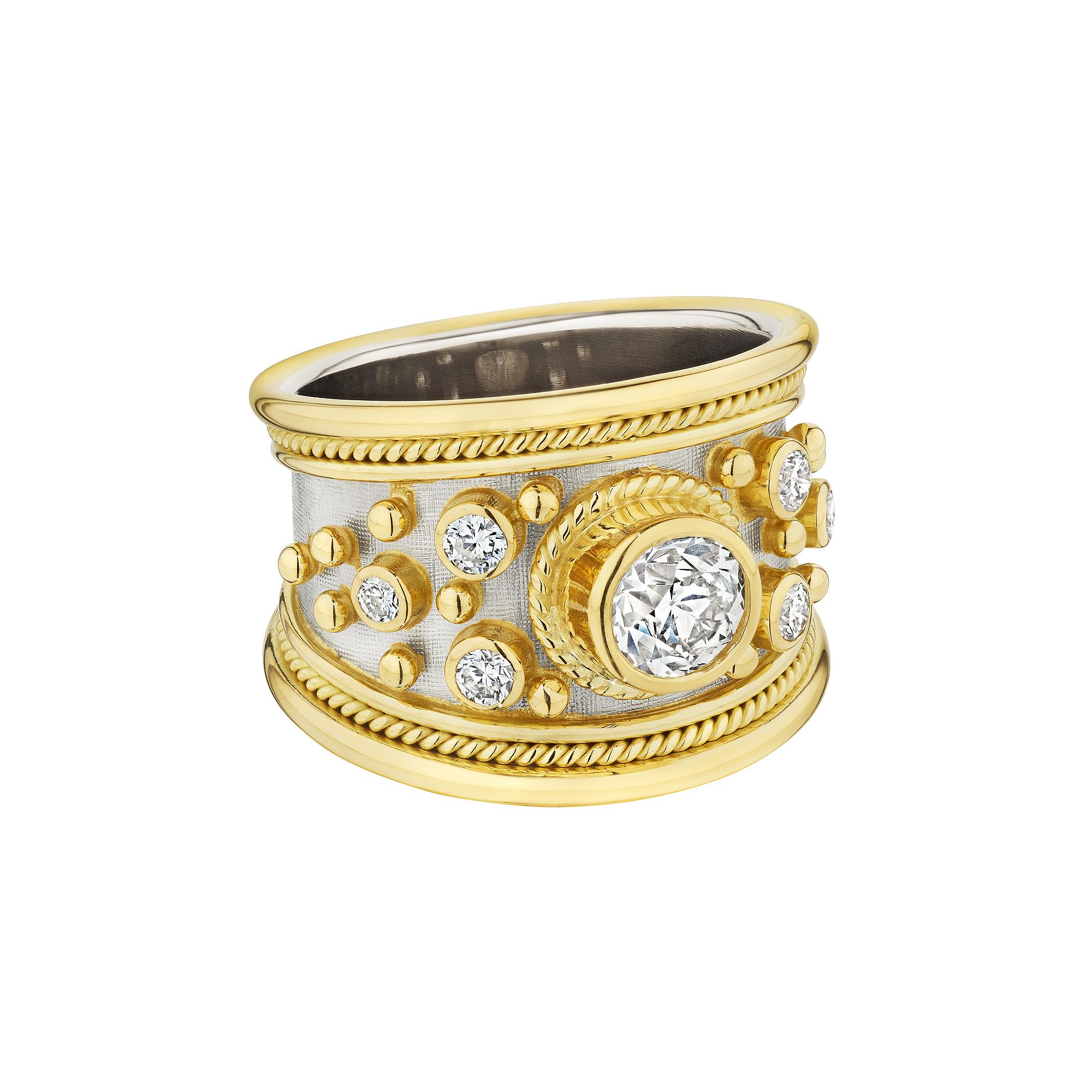 Shimmering like celestial stars from afar this Elizabeth Cage 'Templar' diamond white and yellow 18 karat gold band ring is heavenly. With a .75 carat round cut center bezel set diamond and six round cut side diamonds interspersed with gold beading,