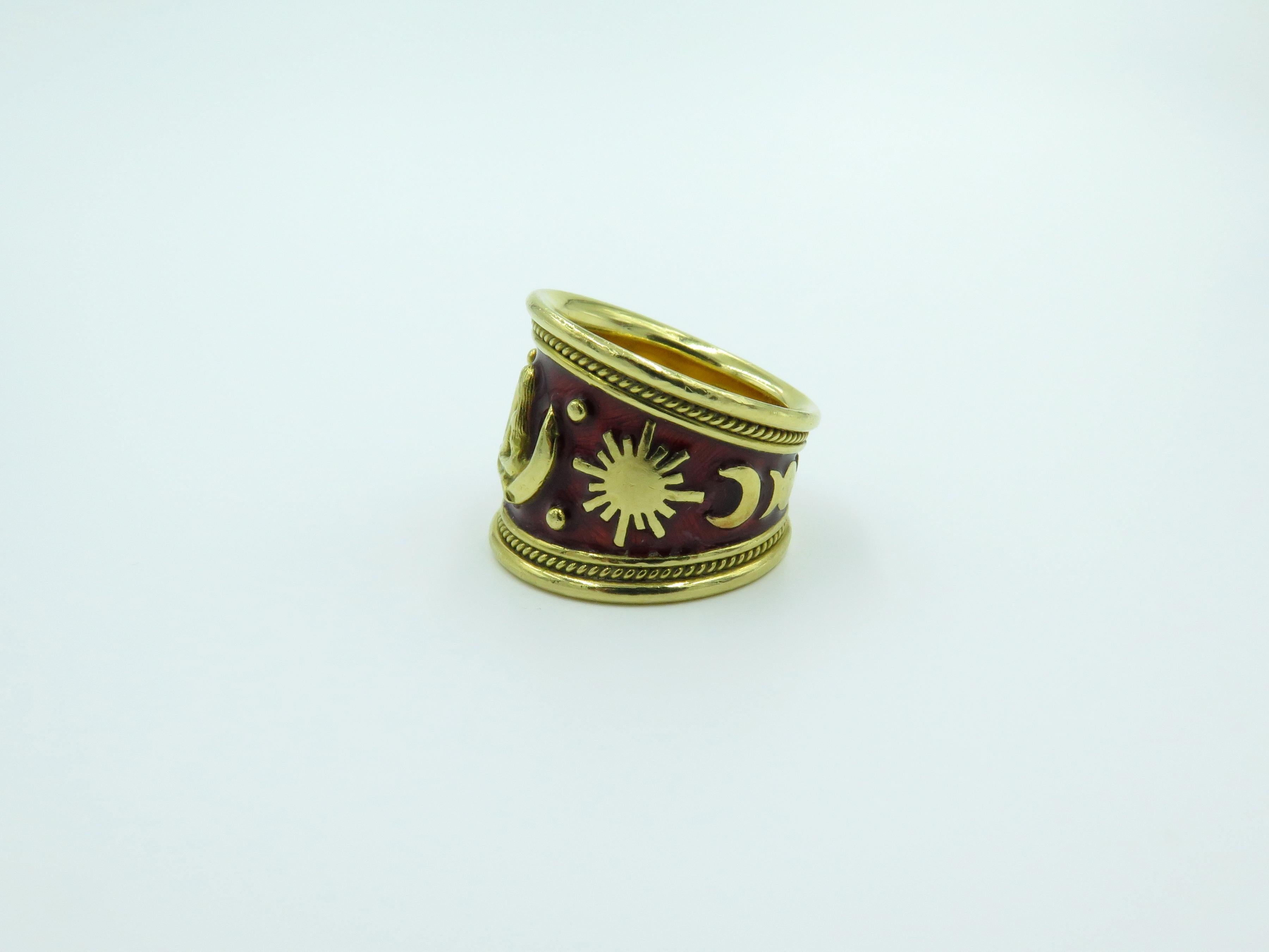 An 18 karat yellow gold and red enamel Virgo ring, from the Zodiac collection. Elizabeth Gage. The tapered red enamel band set with polished gold astrological symbols. Stamped Gage, with English assay mark and maker’s mark. Size 6 1/2. Gross weight