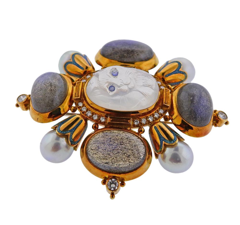 18k gold brooch featuring labradorite, approximately 0.60ctw of G/VS diamonds, pearls measuring 8.5mm and a carved cat moonstone. Brooch is 55mm x 53mm, weighs 45.1 grams. Marked: Gage, English gold assay marks.