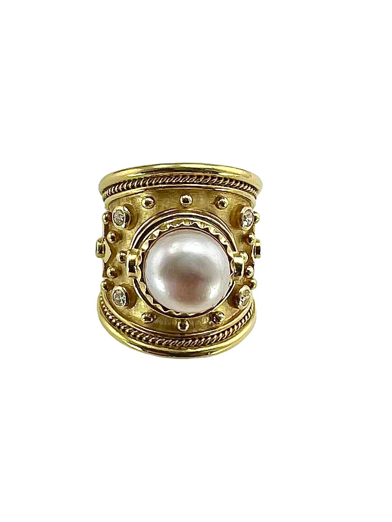 Elizabeth Gage Pearl Diamond Yellow Gold Ring, Ca 1999.  The ring is a size 6.

SPECIFICATIONS:

PEARL: 1 Button pearl, approximately
9.45 mm (3/8”) wide.

DIAMONDS: 8 round brilliant cuts totaling approximately 0.36 carat ( approximately G-H color,
