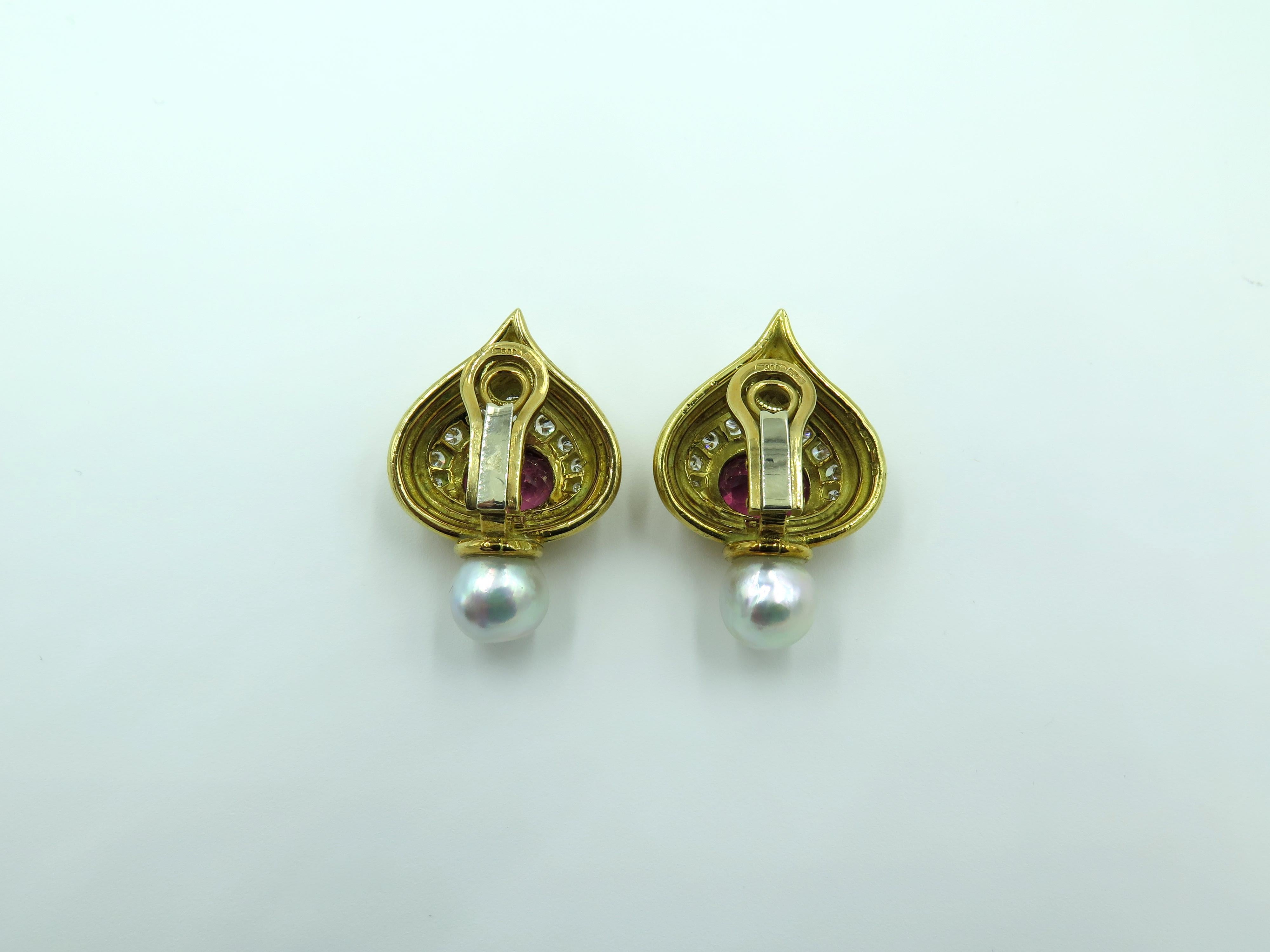 A pair of 18 karat yellow gold, pink tourmaline, pearl and diamond Shiraz earrings. Elizabeth Gage. Of polished and fluted drop shape design, set with an oval cut pink tourmaline, measuring approximately 10.00 x 8.50 x 6.00mm, and weighing