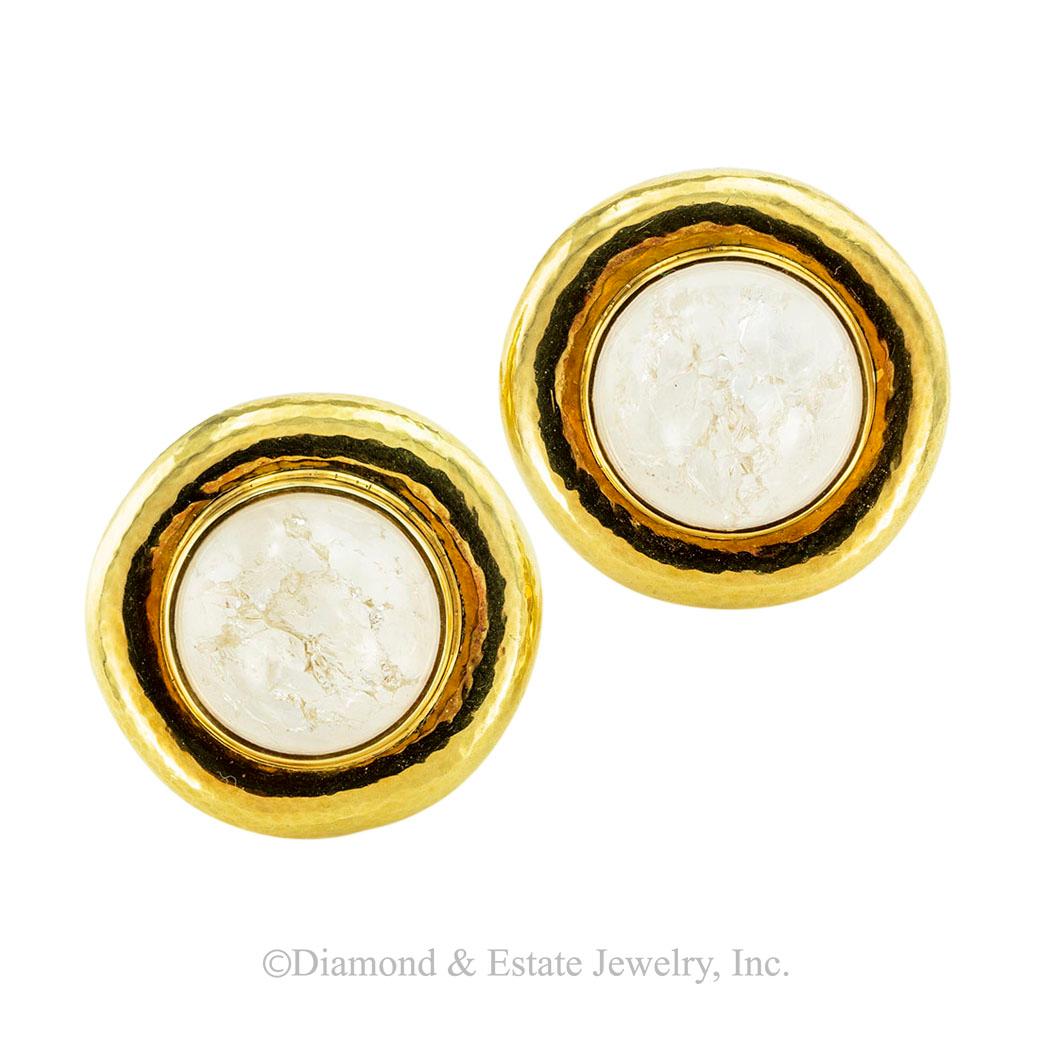 Elizabeth Gage rock crystal and yellow gold round clip-on earrings circa 2001. *

SPECIFICATIONS:

GEMSTONES:  two white rock crystal quartz cabochons with crystallization.

METAL:  18-karat yellow gold decorated by a very soft hammered