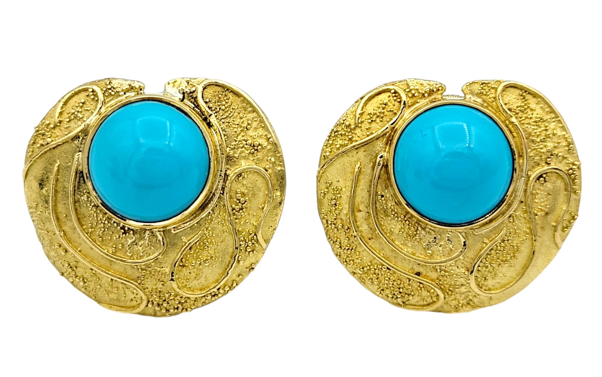 Embrace timeless artistry with these stunning Elizabeth Gage clip-on earrings, a true celebration of luxury and design. Each circular earring features a captivating turquoise cabochon at its center, radiating a rich, vibrant hue that evokes the