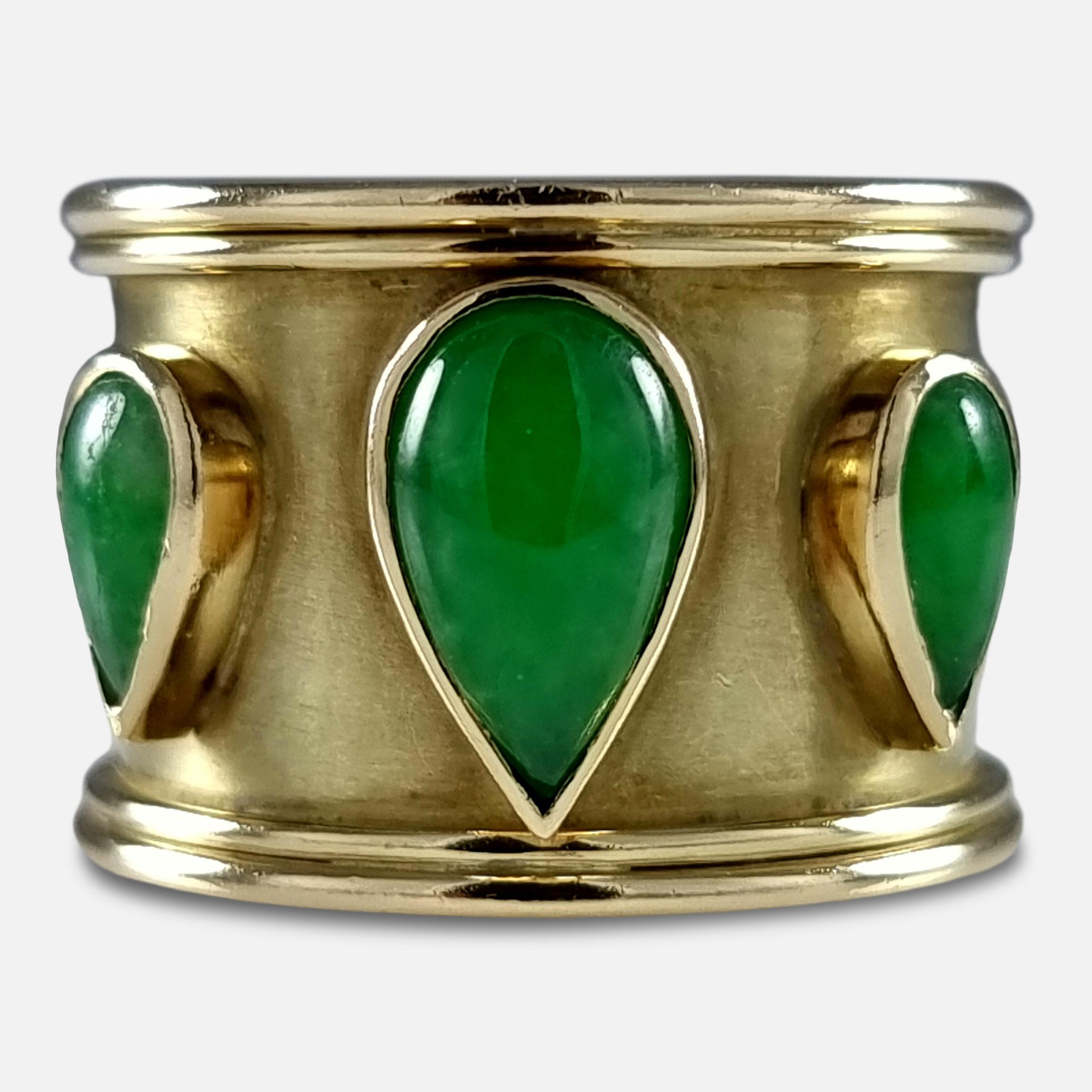 An Elizabeth II 18ct yellow gold nephrite jade ring. The wide gold band is set with three pear-shaped green nephrite jade cabochons

The ring is hallmarked with London marks, '750' for 18 carat gold, and date letter 'S' to denote 1992.

Assay: -