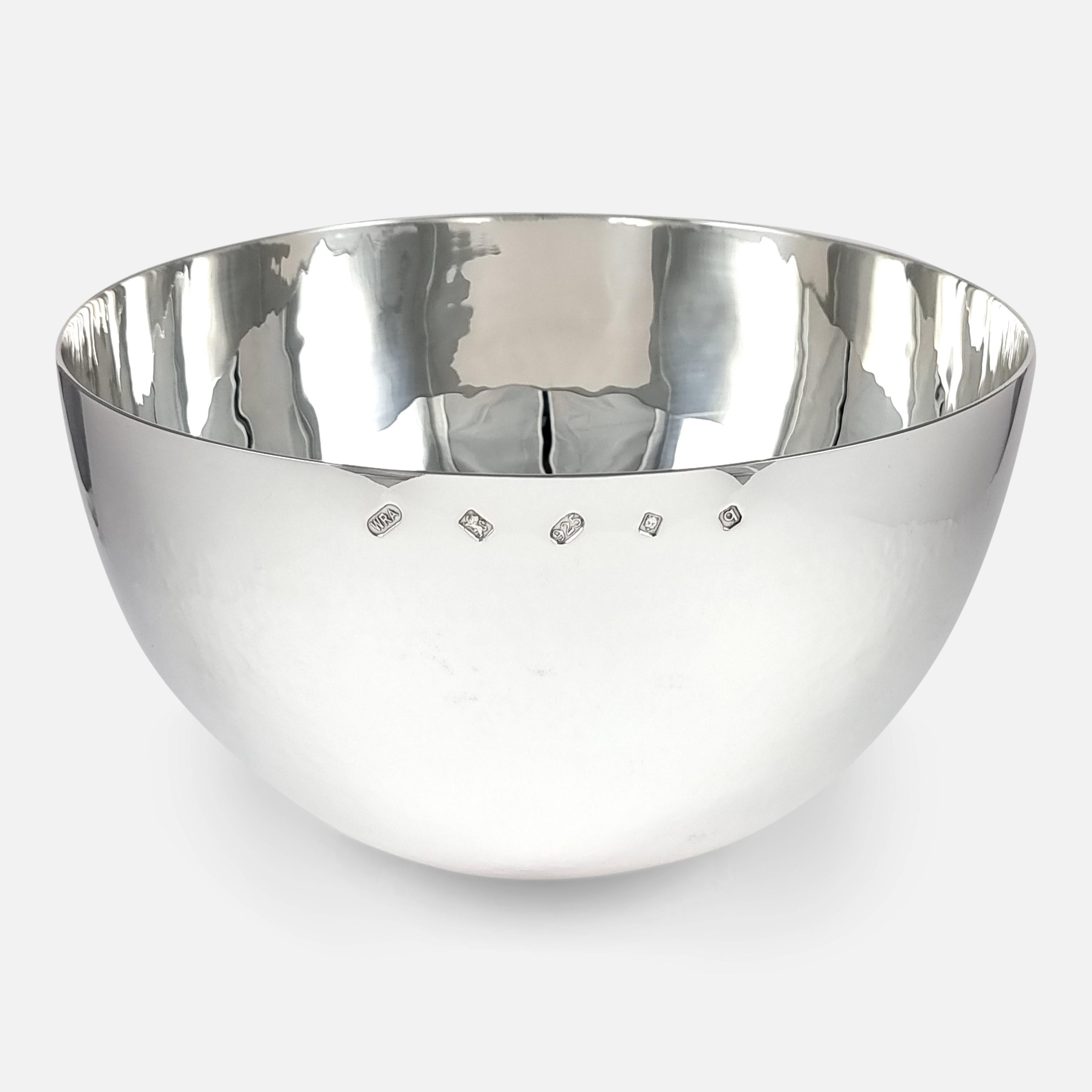An Elizabeth II sterling silver tumble fruit bowl. The planished silver bowl is crafted in the style of an oversized tumbler cup.

It is hallmarked with the makers mark of William & Son (William Asprey), with London assay office marks, and date