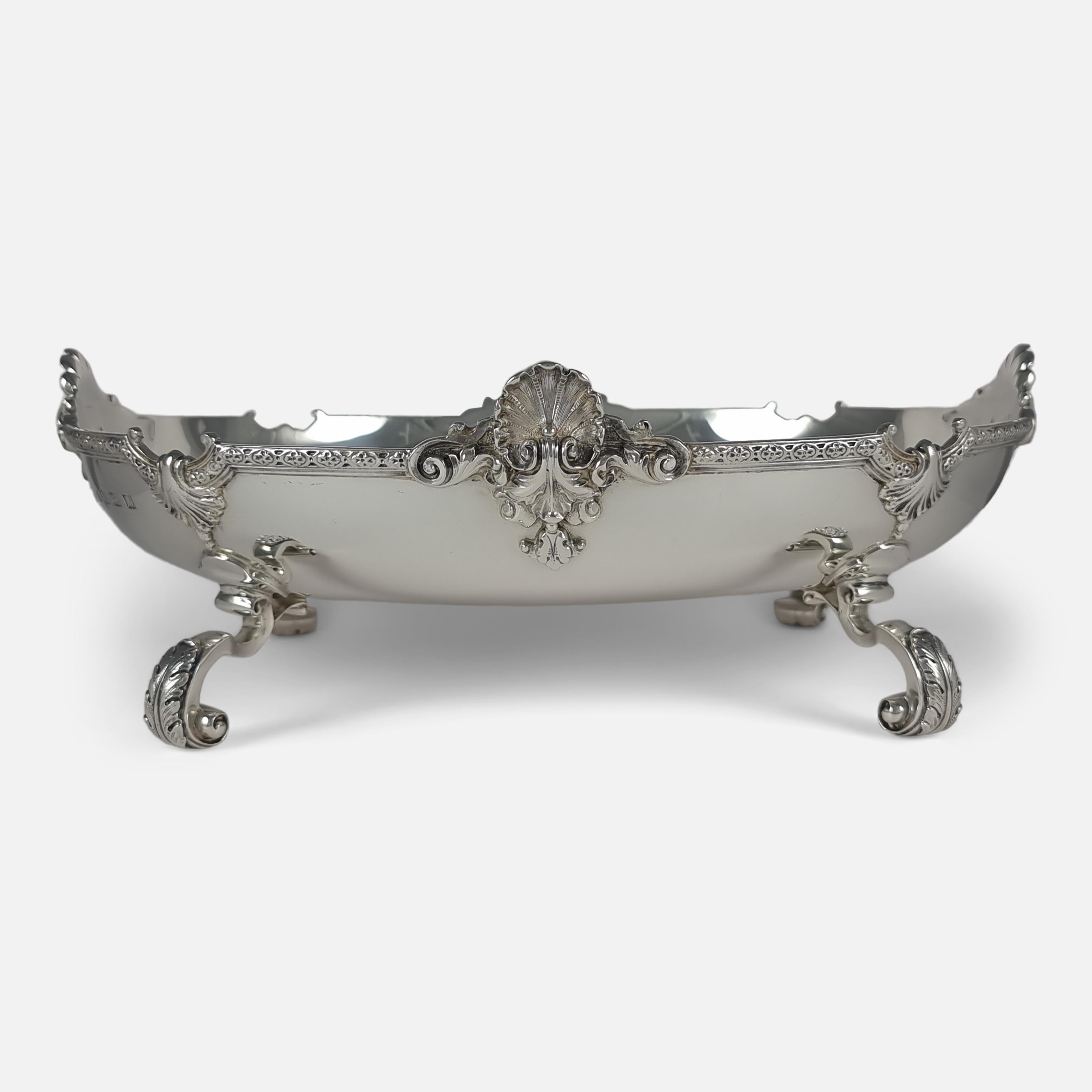 An Elizabeth II sterling silver dish. The dish is of oval form, with a stylised border and shell motifs, on four leaf capped gnarl feet.

The dish is hallmarked with the makers mark of Adie Brothers Ltd, with Birmingham assay marks, and date