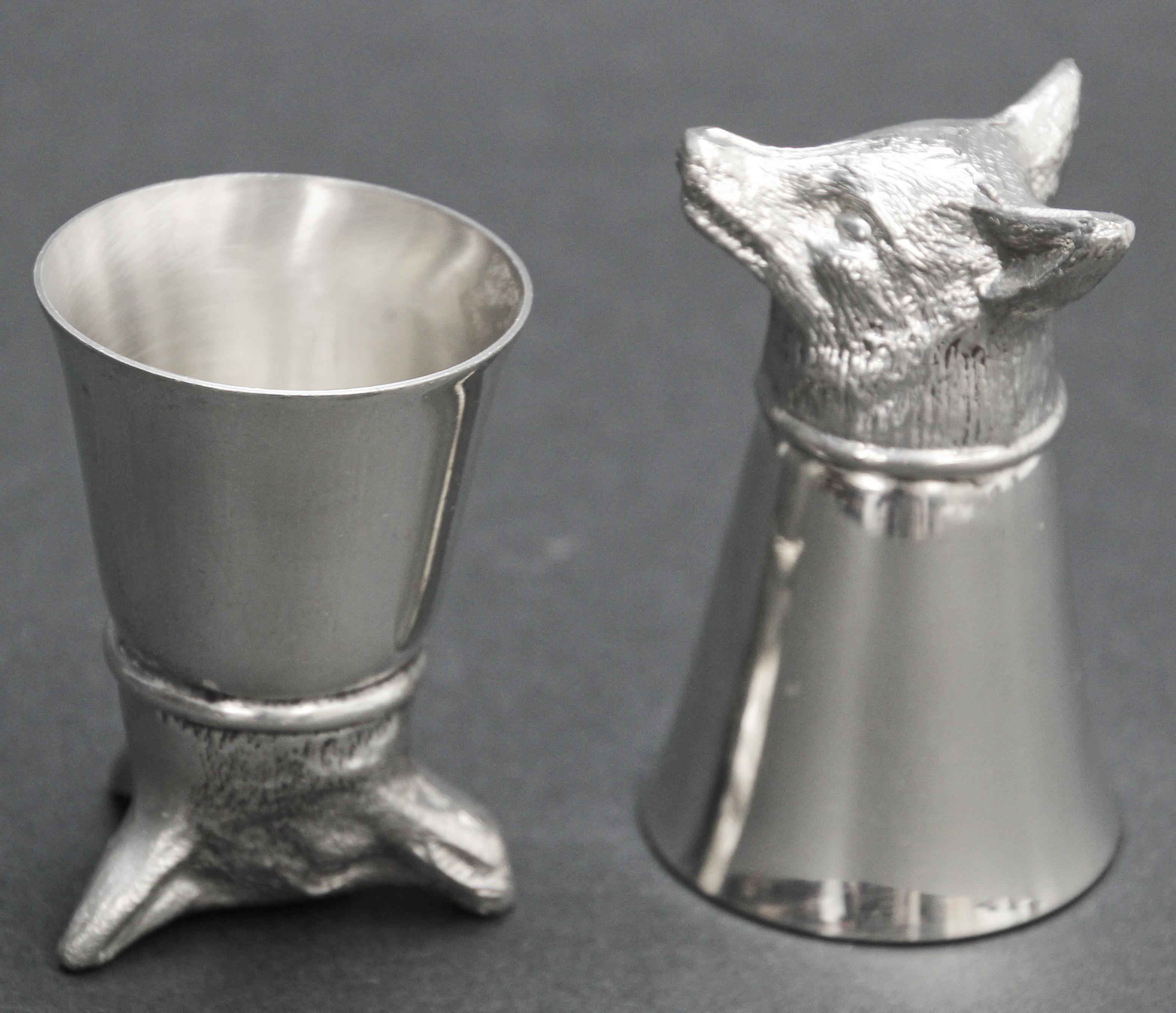 Classic Elizabeth II style stirrup cups, is of plain beaker form with a cast foxes head to one end.
Set of two playful stirrup cups from the 1970s.
Gorgeous stirrup cup adorned with a hand-carved fox head on its base. 
They balance with the