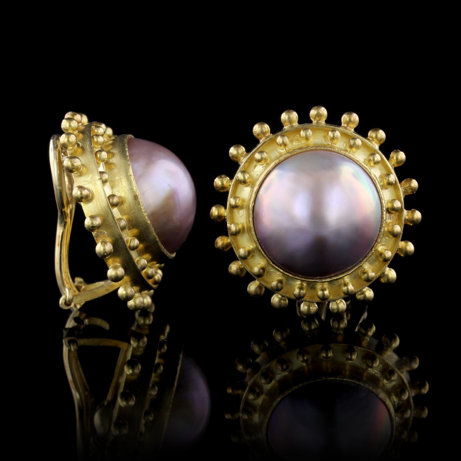Elizabeth Locke 18K Yellow Gold Mabe Pearl Earrings. The earrings are set with two mabe pearls each measuring 15.50mm., framed by hammered gold and beaded accents, diameter 1
