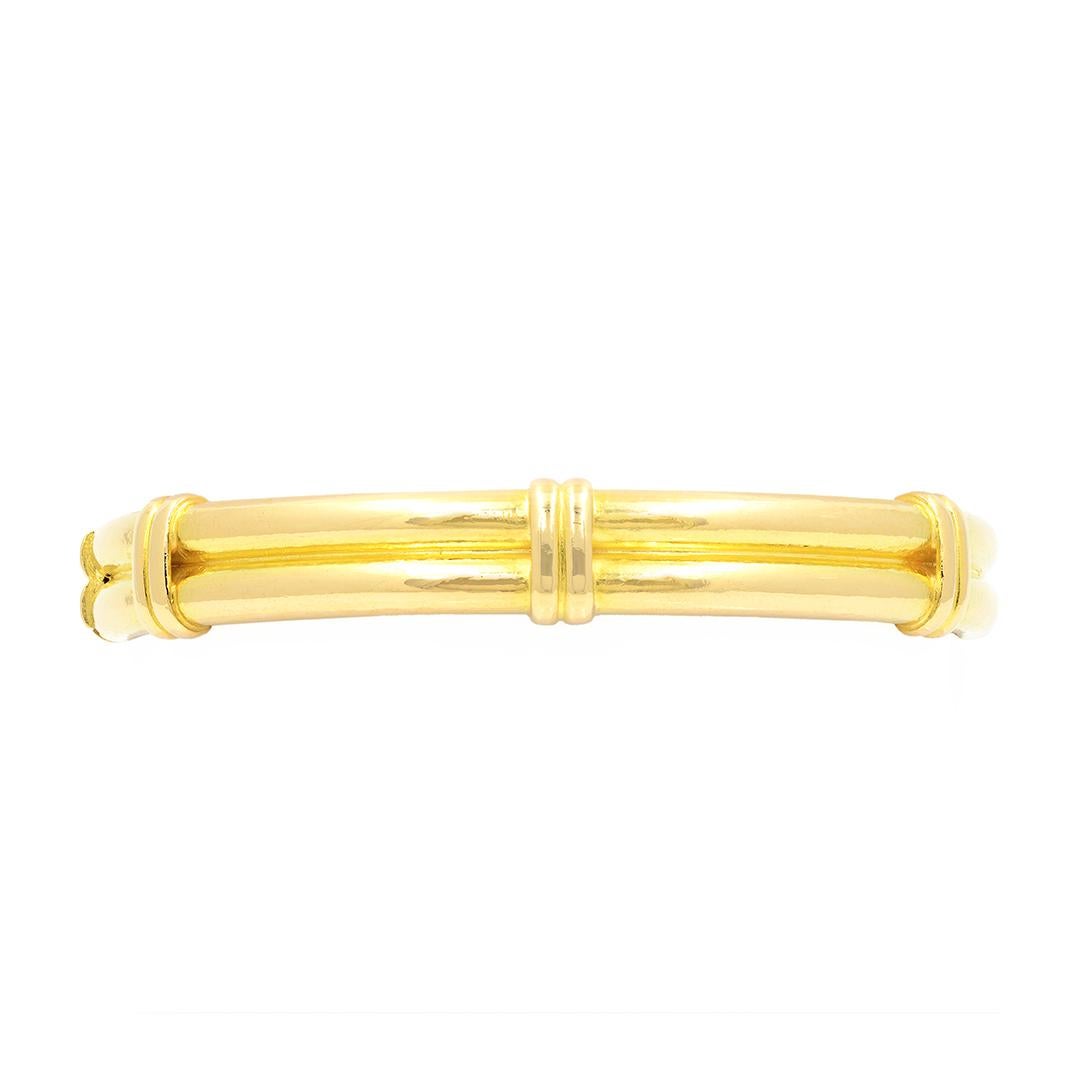 From designer Elizabeth Lock, this 18 karat yellow gold bangle features a double dome shape with vertical bars spaced even around the bracelet. The bangle measures 51.5x58.34mm and has a polished finish.
-	18k Yellow Gold
-	Polished Finish
-	10mm