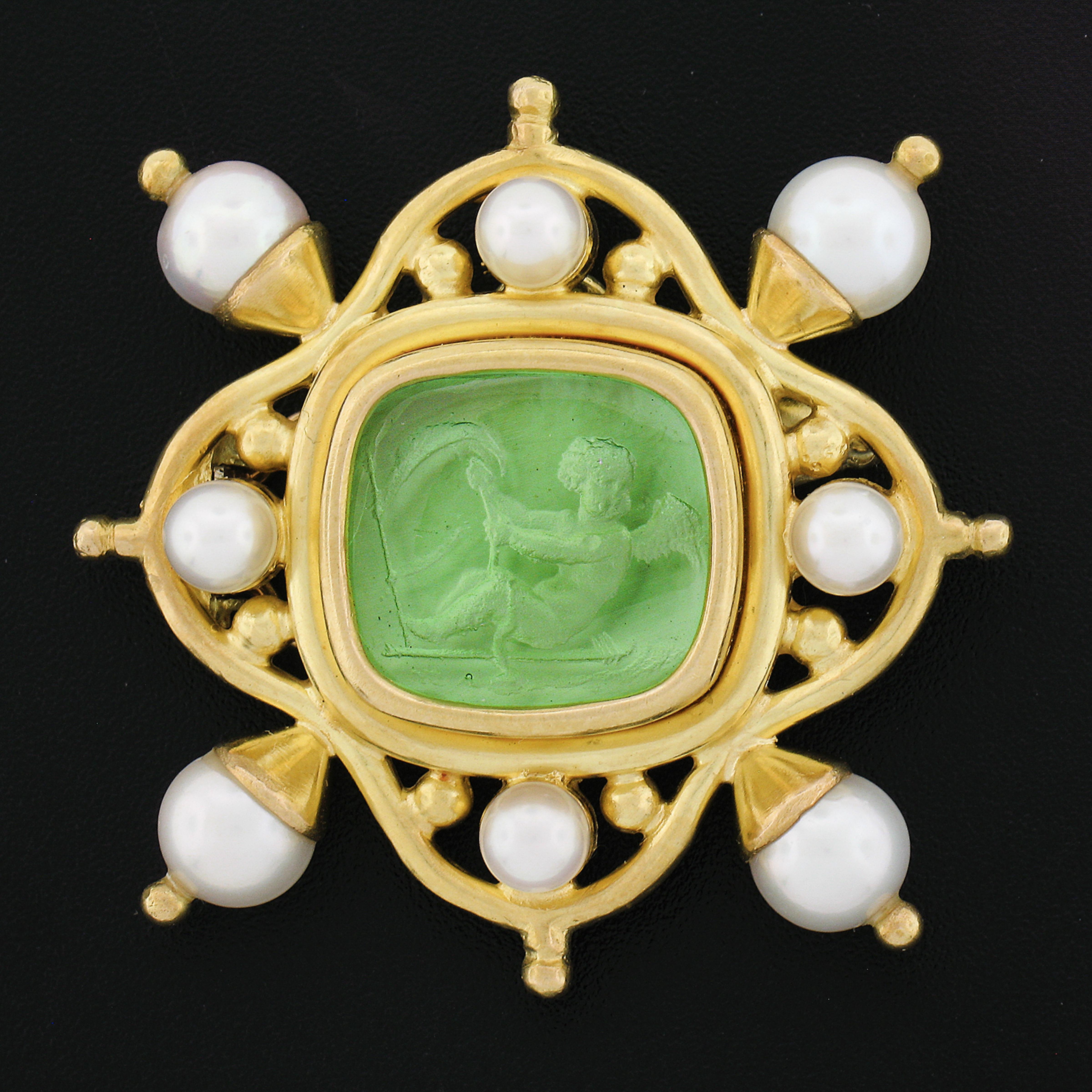 This unique and very well made brooch/pendant is designed by Elizabeth Locke and crafted in solid 18k yellow gold. It features intaglio carved green glass neatly bezel set at its center surrounded by an elegant, polished finish, open work frame