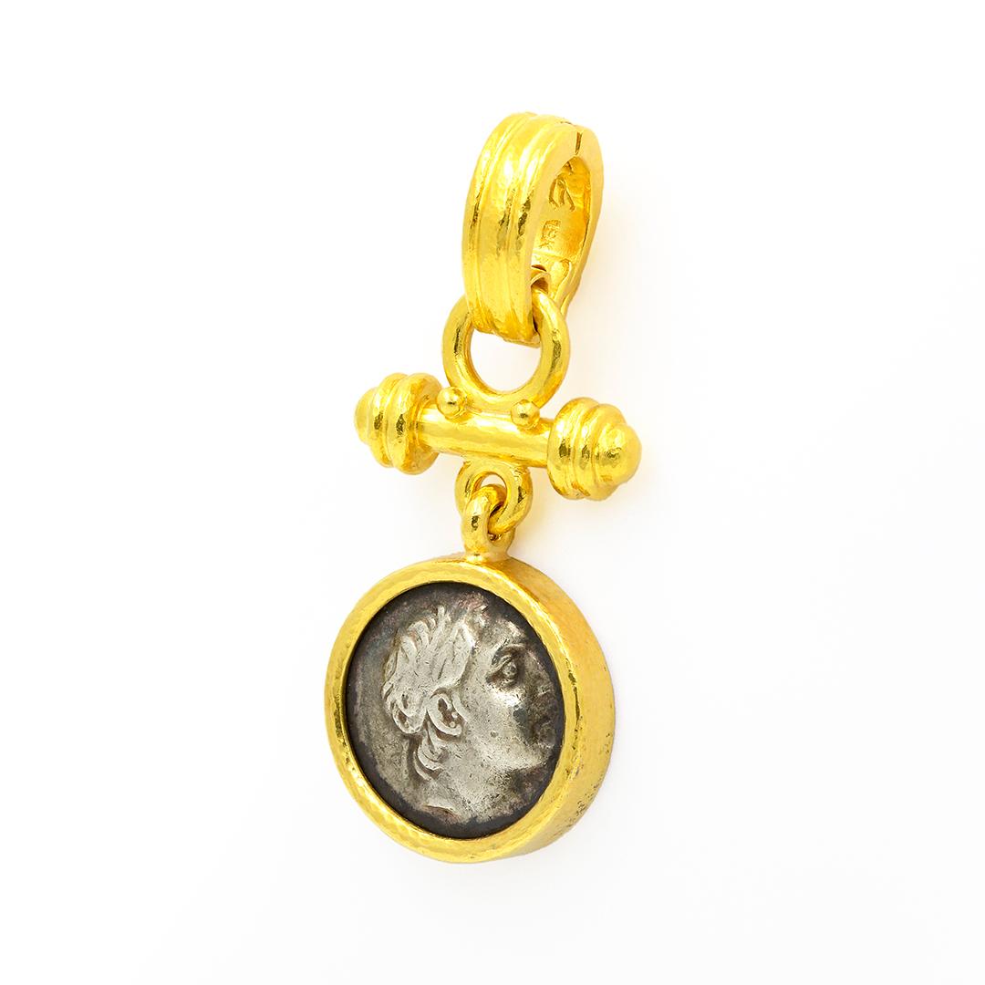 This pendant by Elizabeth Locke features a double sided ancient coin set in 18 karat yellow gold with a hammered finish. The bail is hinged, allowing the pendant to be secured to a variety of things. 

Listing is for pendant only.

- 18k Yellow