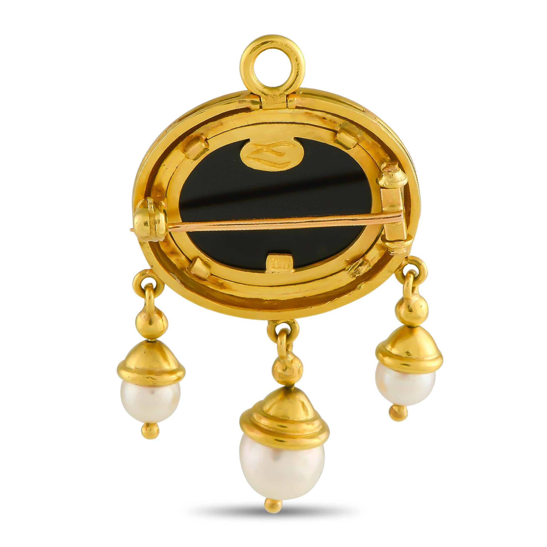 Here is a handmade neoclassical brooch in 18K yellow gold featuring a recessed image of Medusa, a Greek mythology figure engraved in a glass and onyx doublet. Dangling from the oval brooch are trios of cultured pearls with gold caps. This Elizabeth