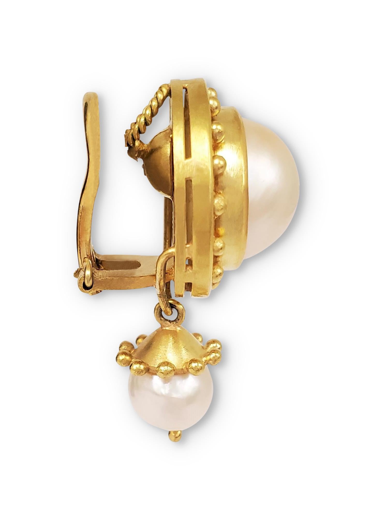 Authentic Elizabeth Locke ear clips crafted in 18 karat yellow gold.  Each clip-on earring centers on a 12mm pearl surrounded by a beaded gold bezel and featuring a 7mm pearl suspended from an 18 karat yellow gold cap.  Signed E, 18K.  CIRCA 2010s
