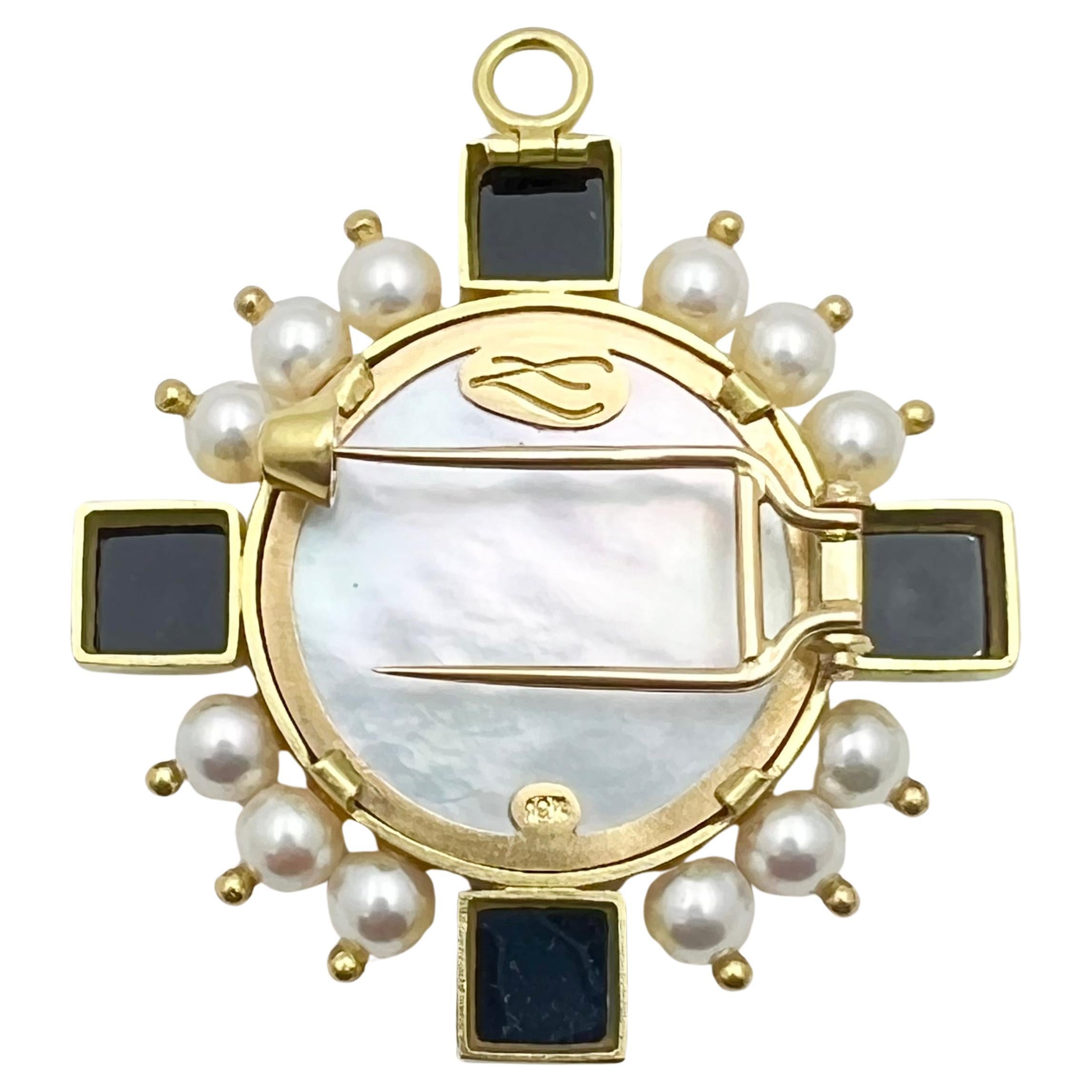 Elizabeth Locke intaglio pendant brooch, centering a deep red Venetian glass carved intaglio of Cupid riding a lion backed by mother-of-pearl and bezel-set in a polished 19k yellow gold frame.  The frame is further accented by four square sugarloaf